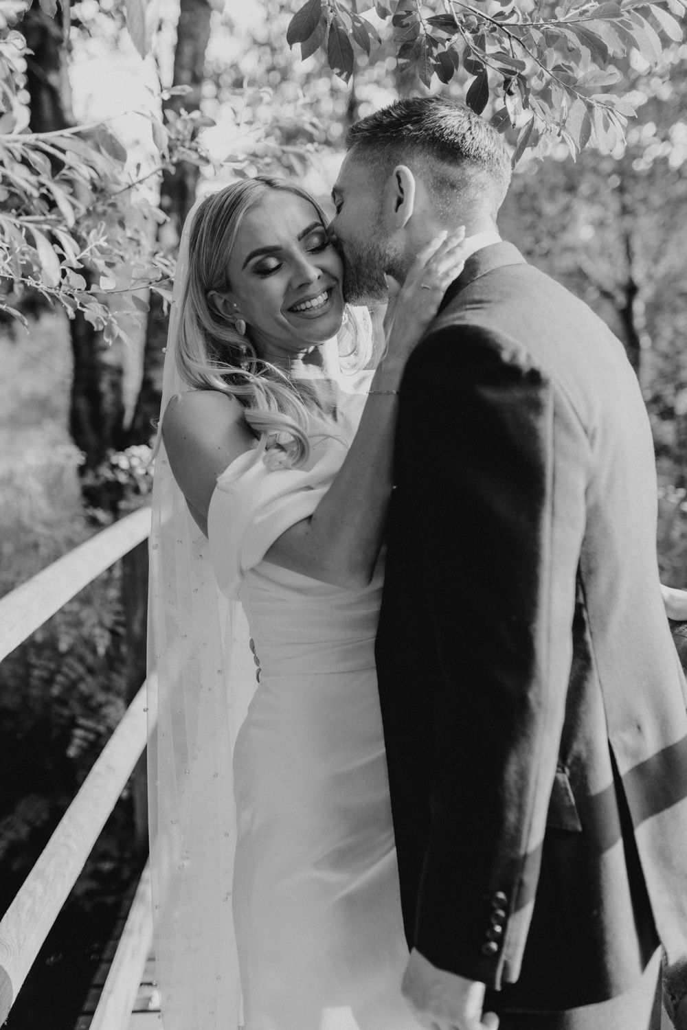Black and white candid wedding moments captured in natural setting.
