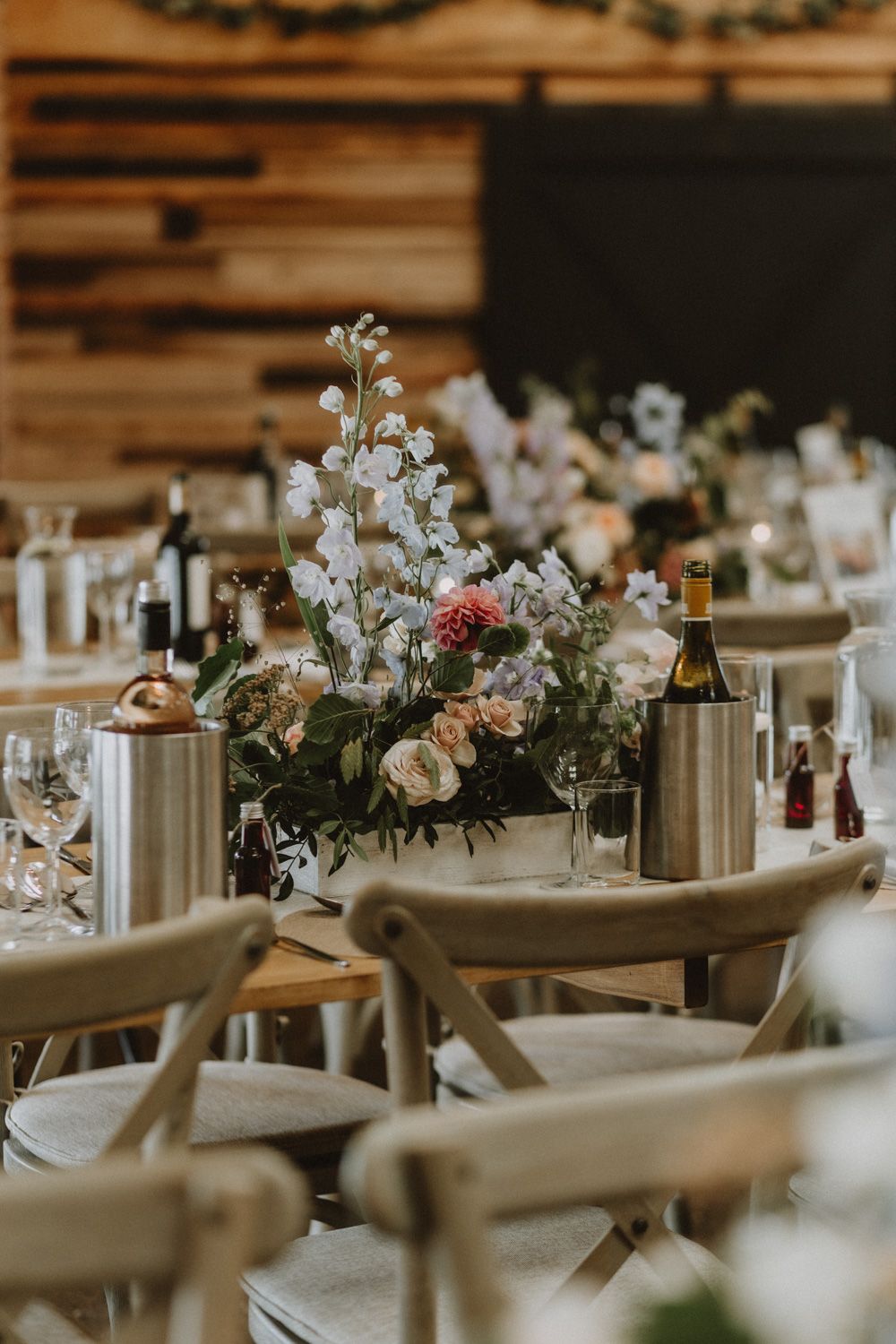 Wedding reception tables set with white linens and delicate floral centerpieces.