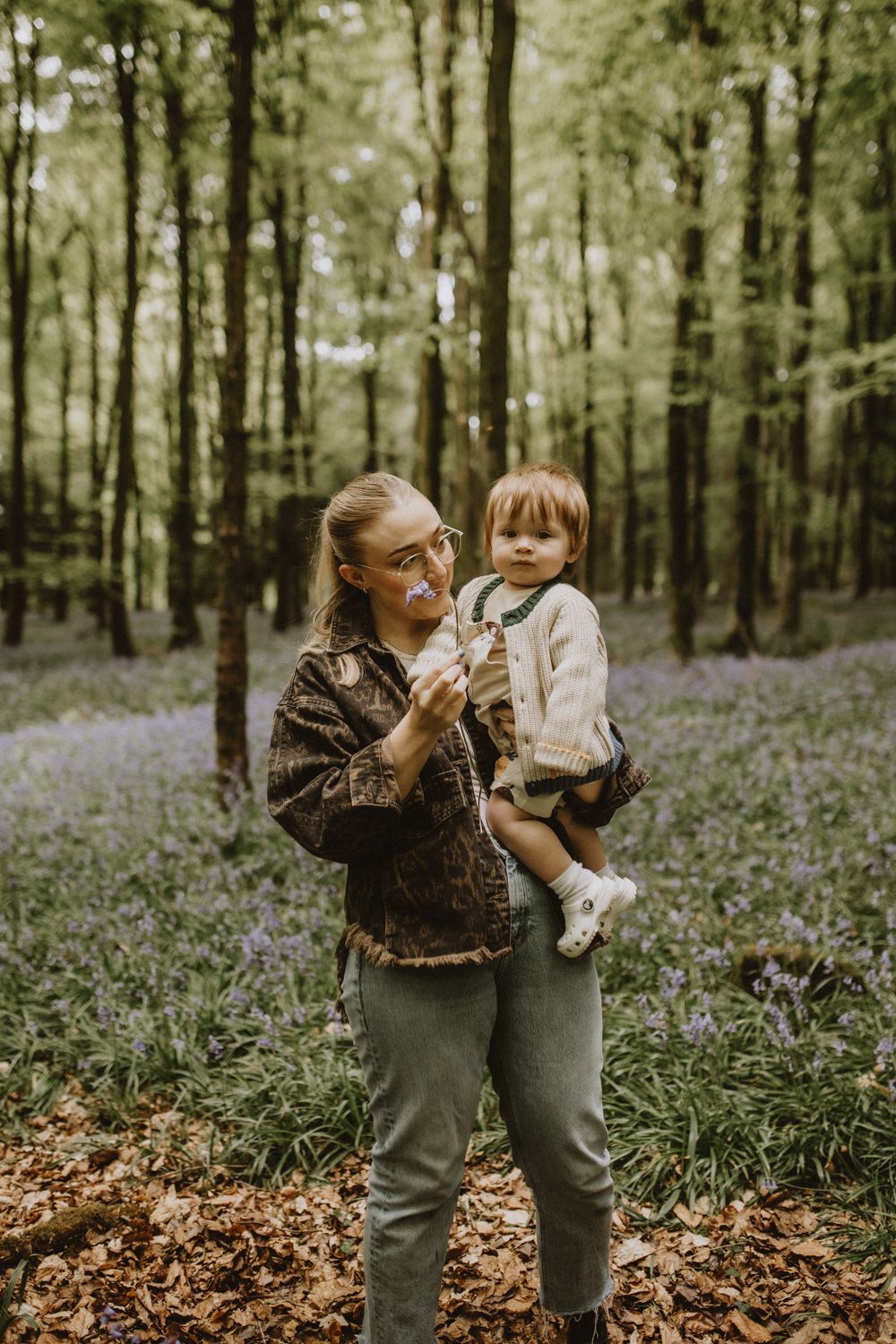 Precious moments shared between two people in a bluebell-covered forest floor.