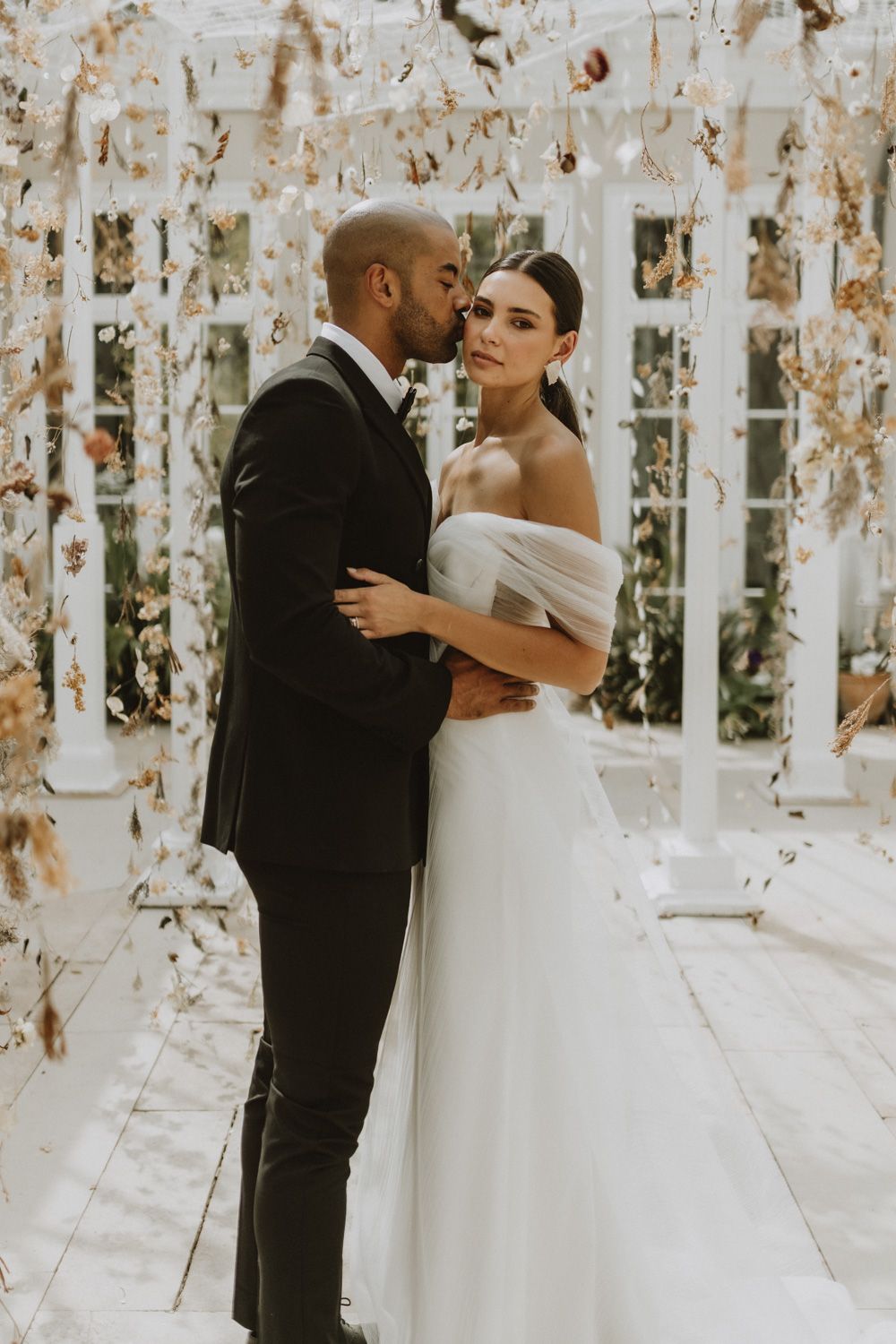 Celebratory moment with confetti falling during an indoor wedding ceremony.