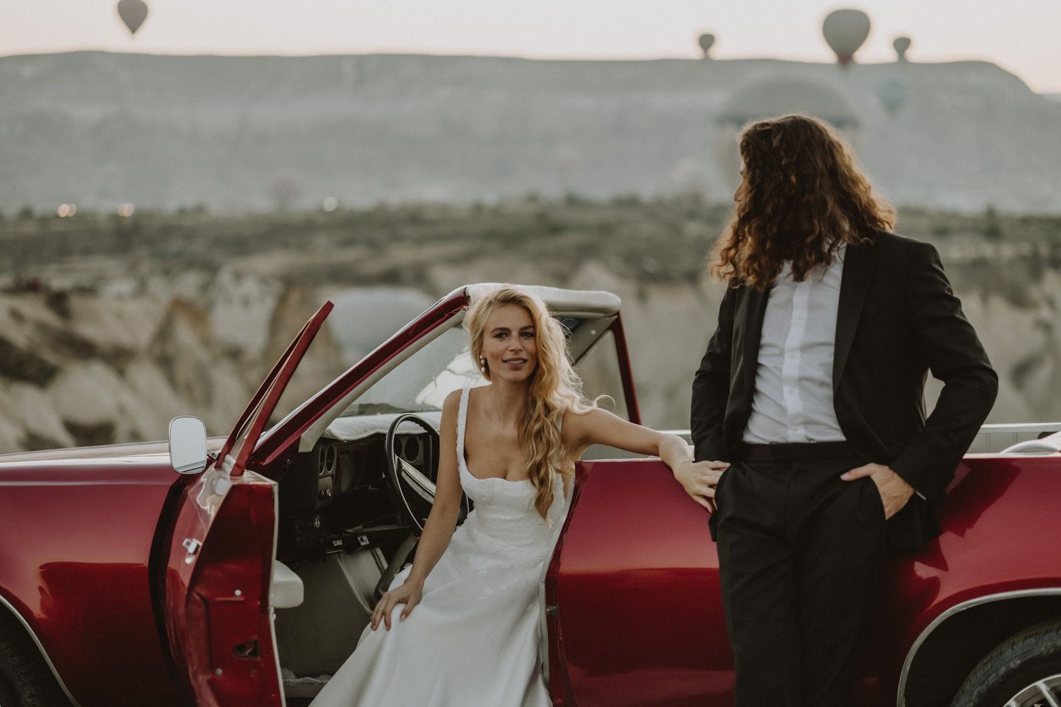 Vintage red car used for wedding photography and celebrations.