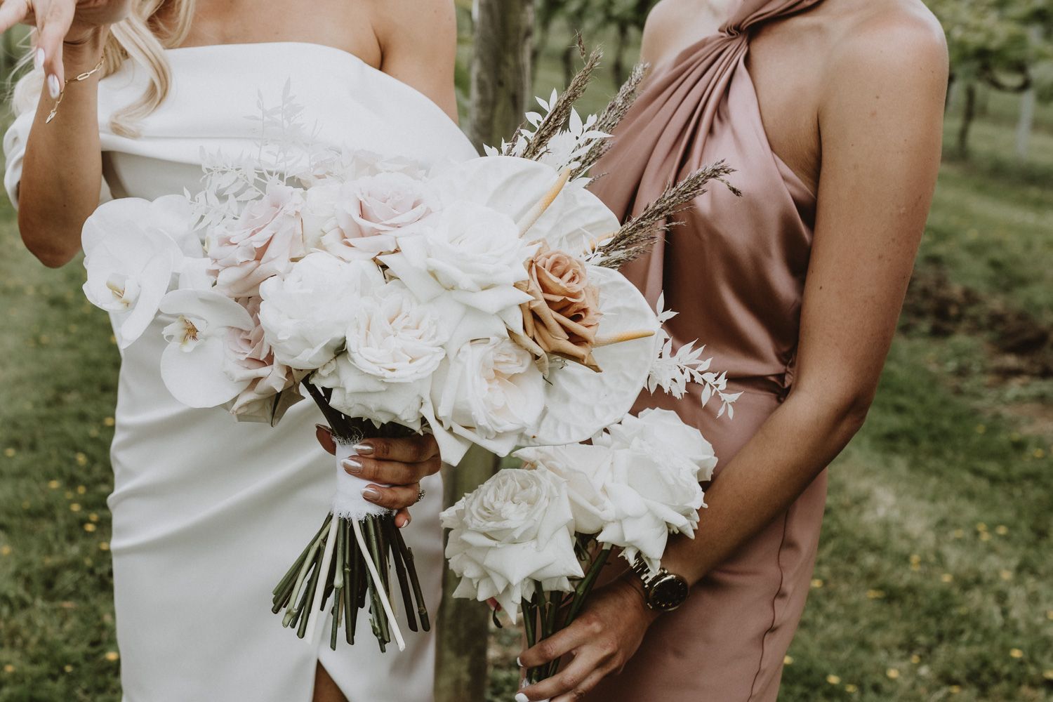 Close-up of elegant white wedding bouquet with blush accents.