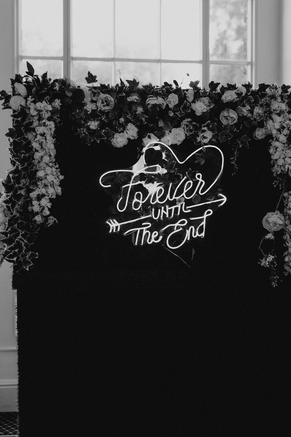 White calligraphic text with words 'The End' and 'Forever' against a black background with floral designs.