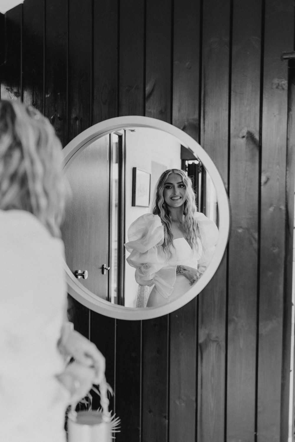 Artistic black and white photo series featuring circular mirrors on dark wall.