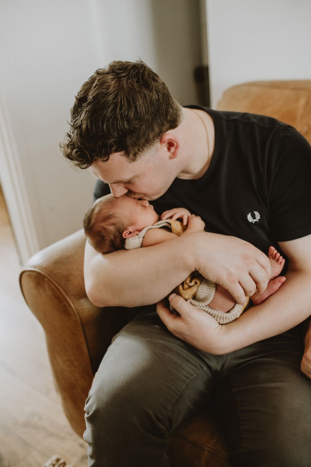 Emotional lifestyle photography session capturing tender moments on couch.