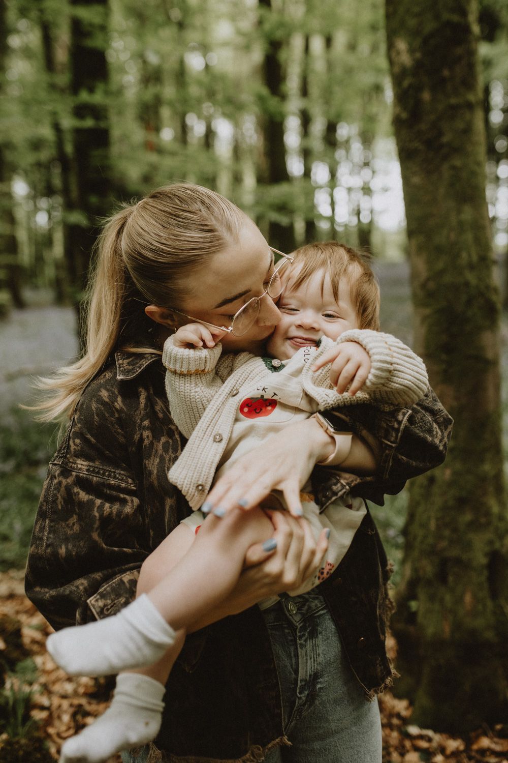 Joyful embrace shared in a serene forest setting.