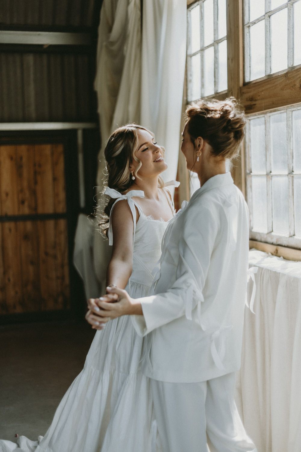 A romantic dance captured in golden sunlight streaming through industrial windows.