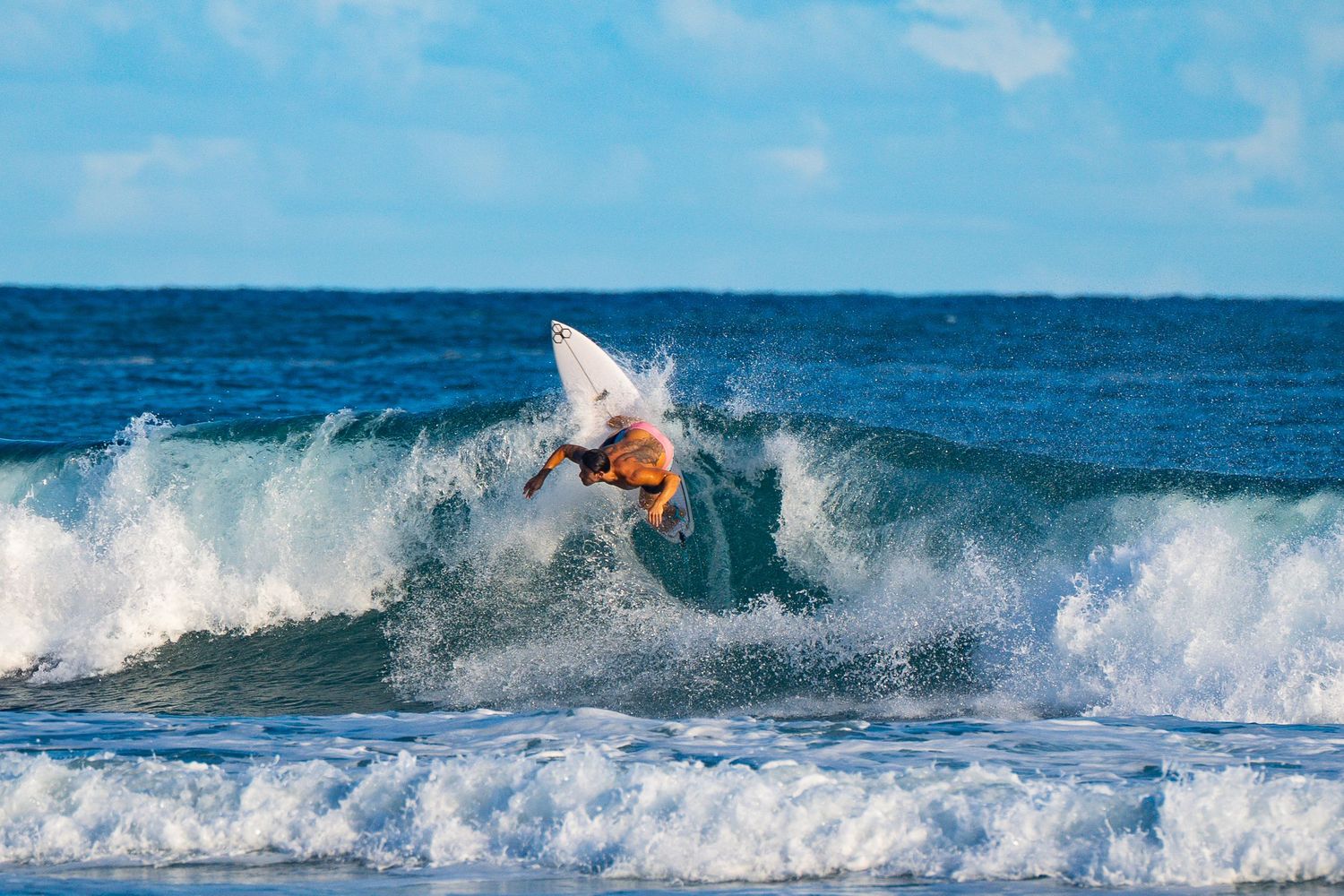 Surfer bottom turning on a clean right-hander, shot from shore – CK Surf