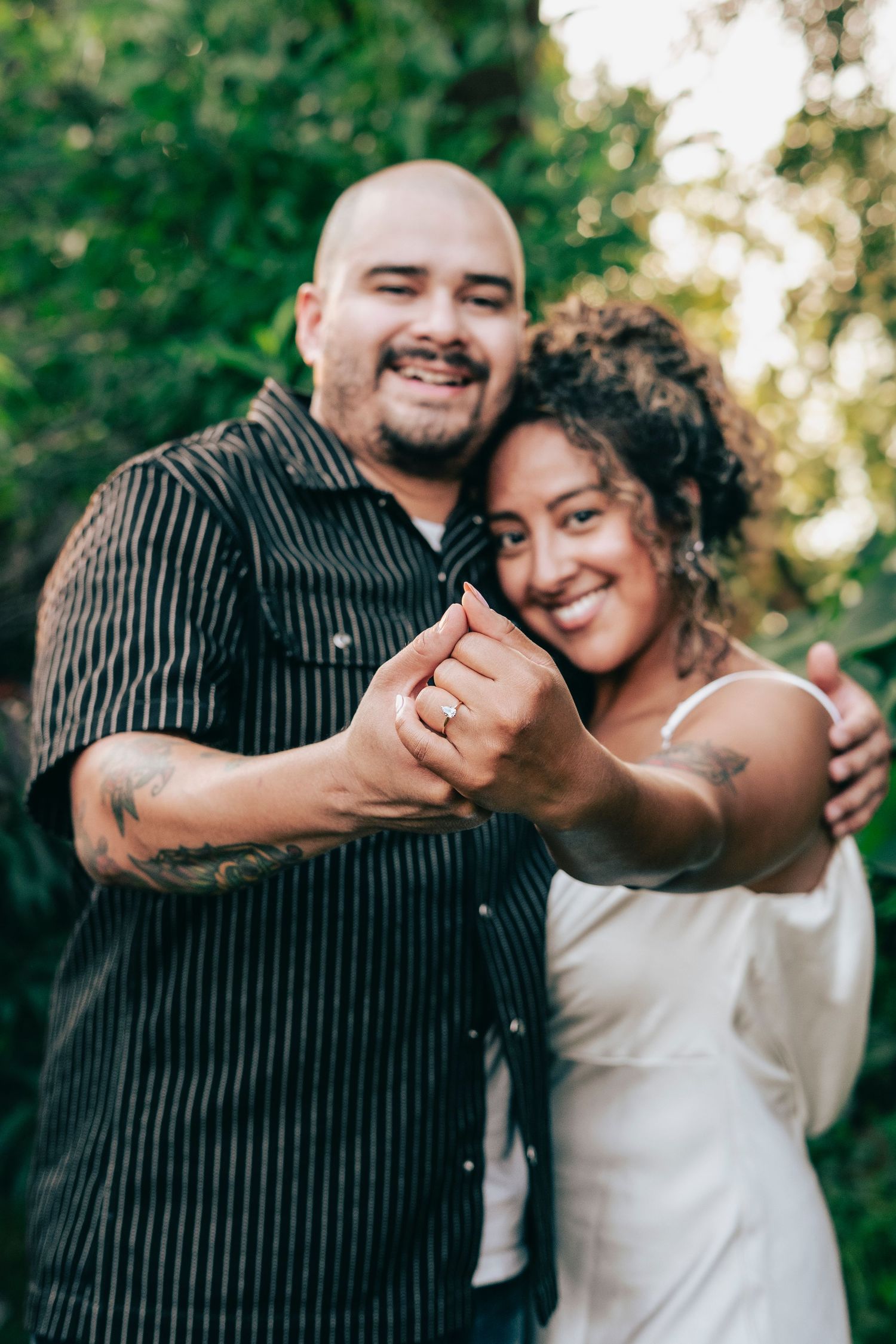 A joyful couple embraces and laughs together outdoors in a series of candid romantic photos.
