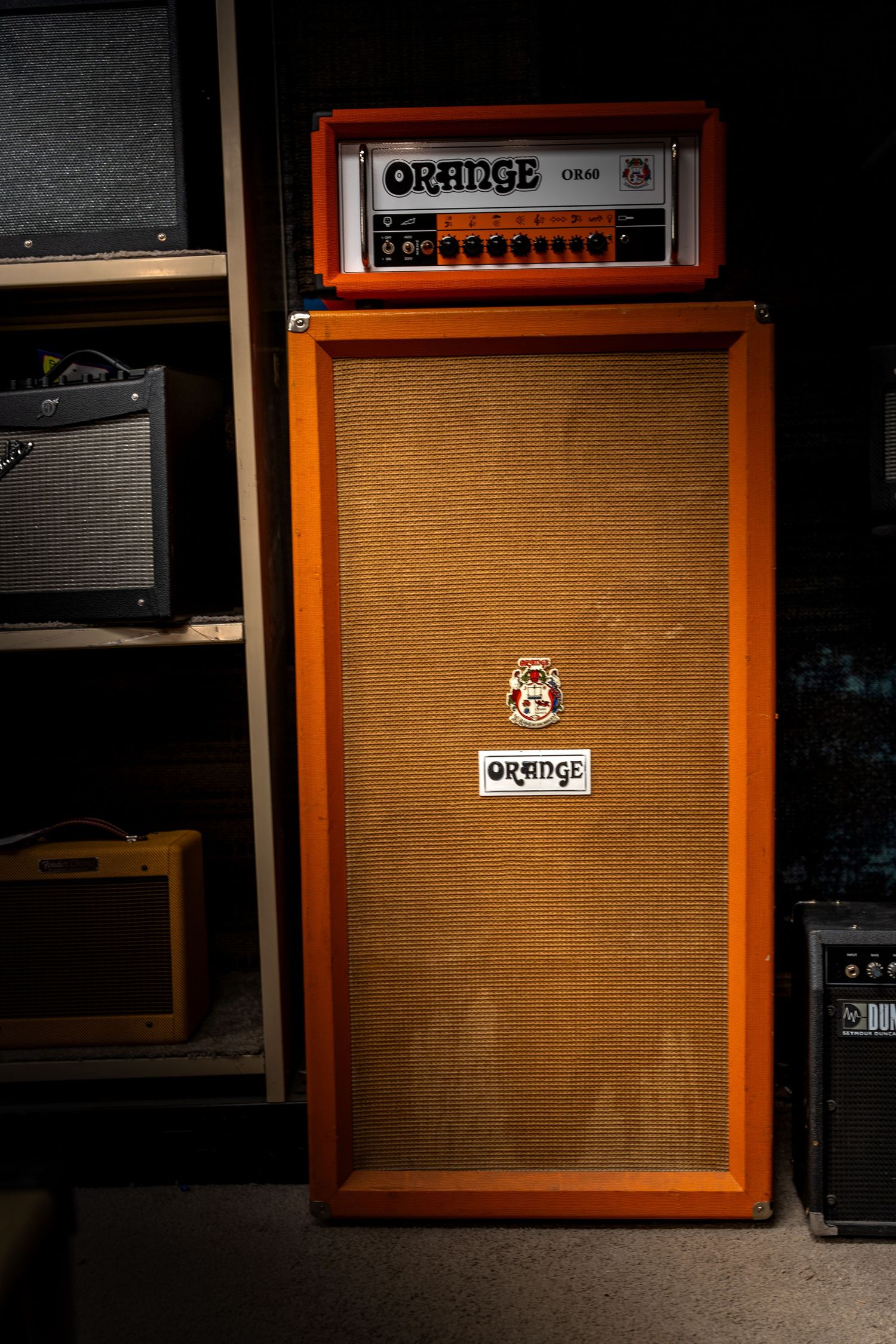 Orange OR80 guitar amp head on an Orange 4x12 speaker cabinet in a music studio.