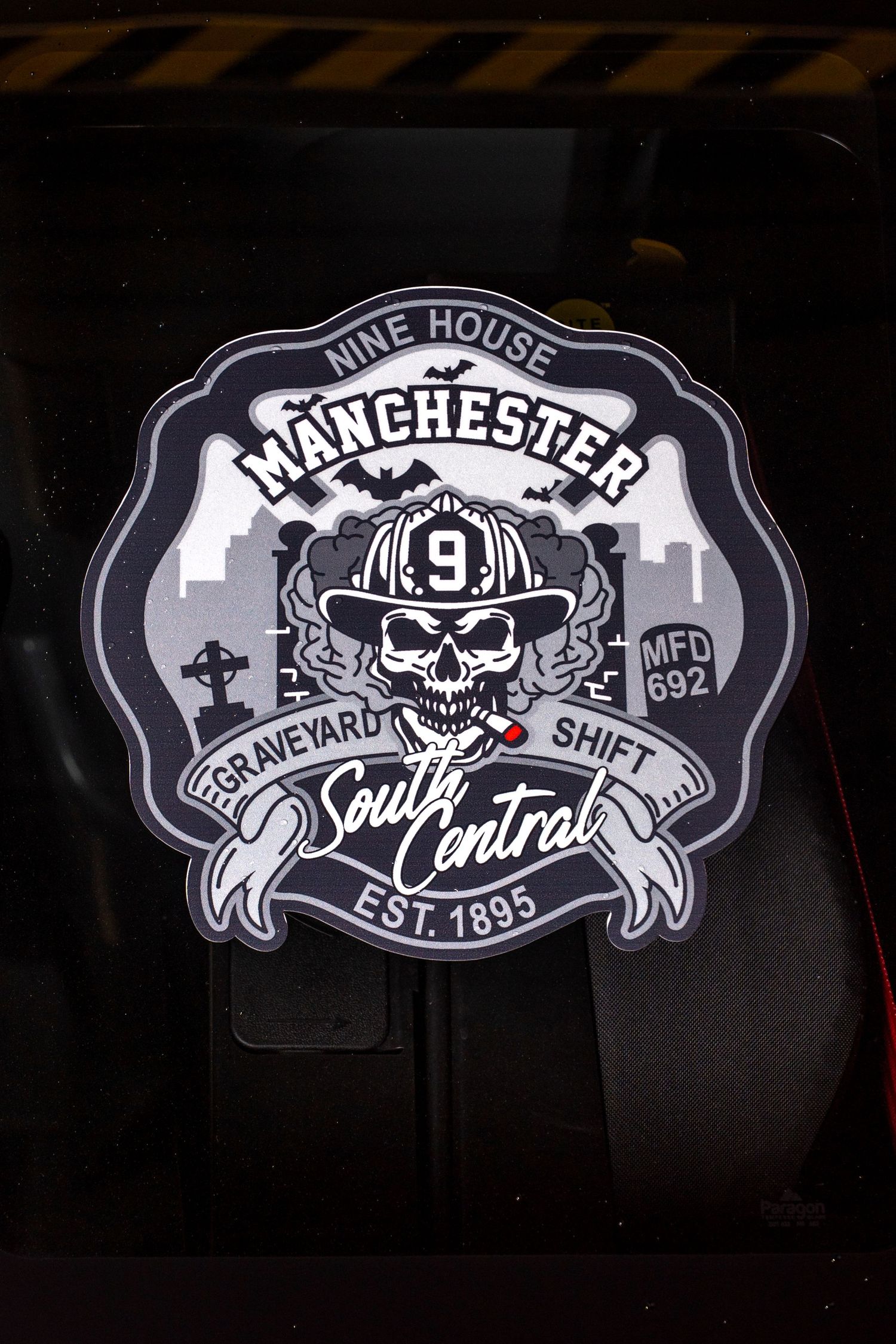 Manchester South Central graveyard shift firefighter skull badge sticker with Nine House MFD 692 Est. 1895 emblem.