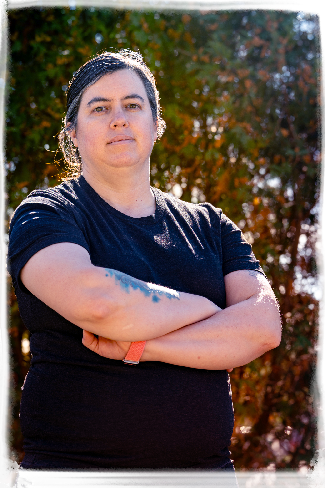 A series of four connected photos showing someone in a black shirt with crossed arms against an outdoor autumn background.