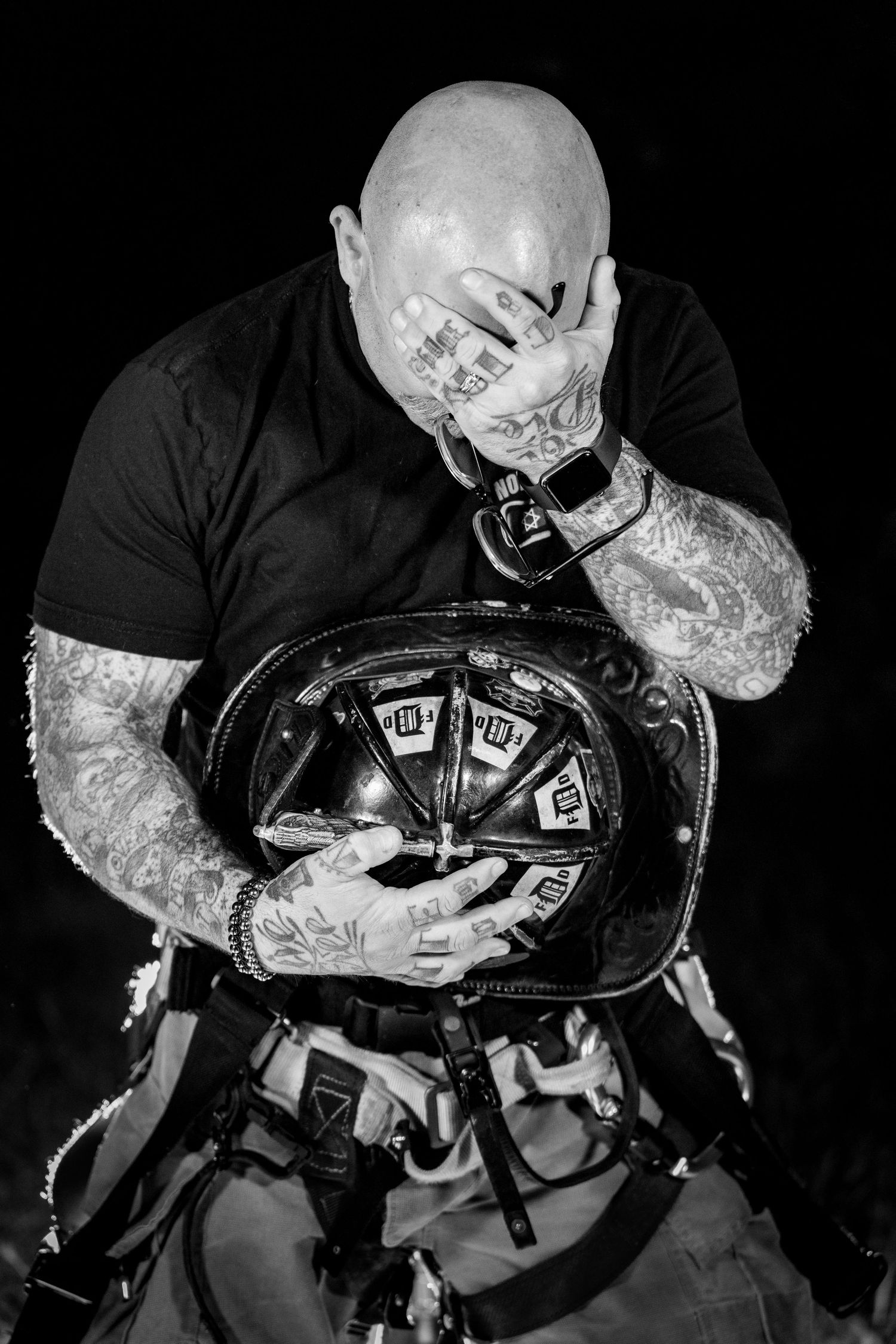 Dramatic black and white sequence of a firefighter performing an emergency rescue with breathing apparatus.