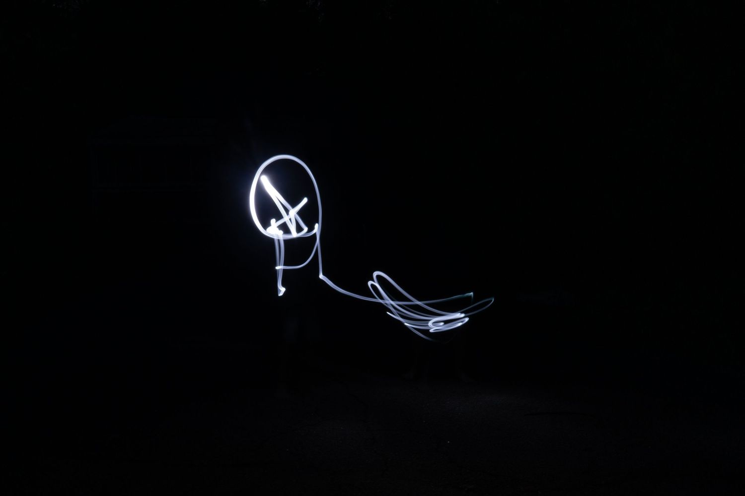 White light painting art creates abstract shapes on a black background.