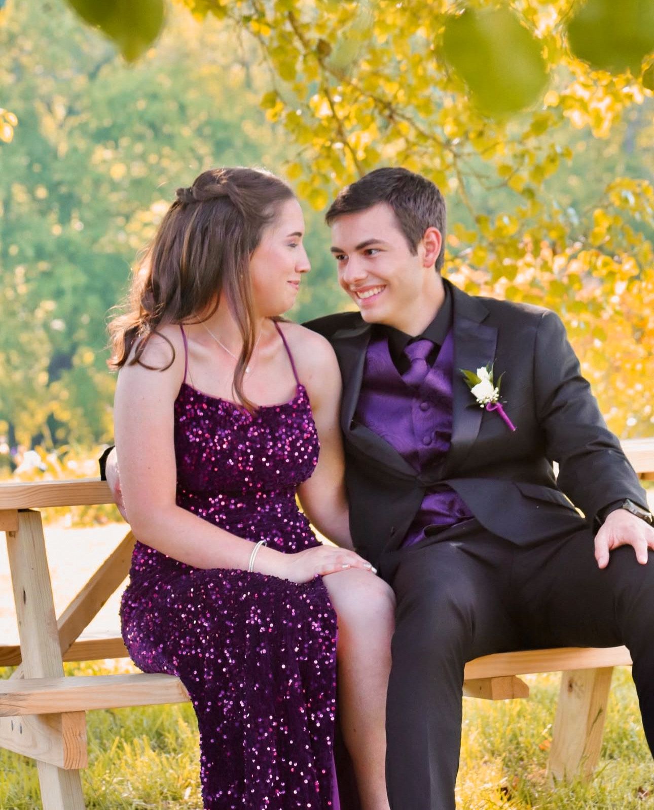 Sweet candid moment of a couple sitting together leaning in for an intimate, natural portrait.