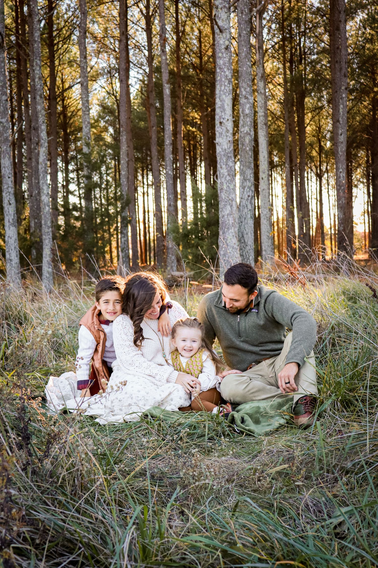 Lifestyle family session with four people taken outdoors in natural light, candid photography style.