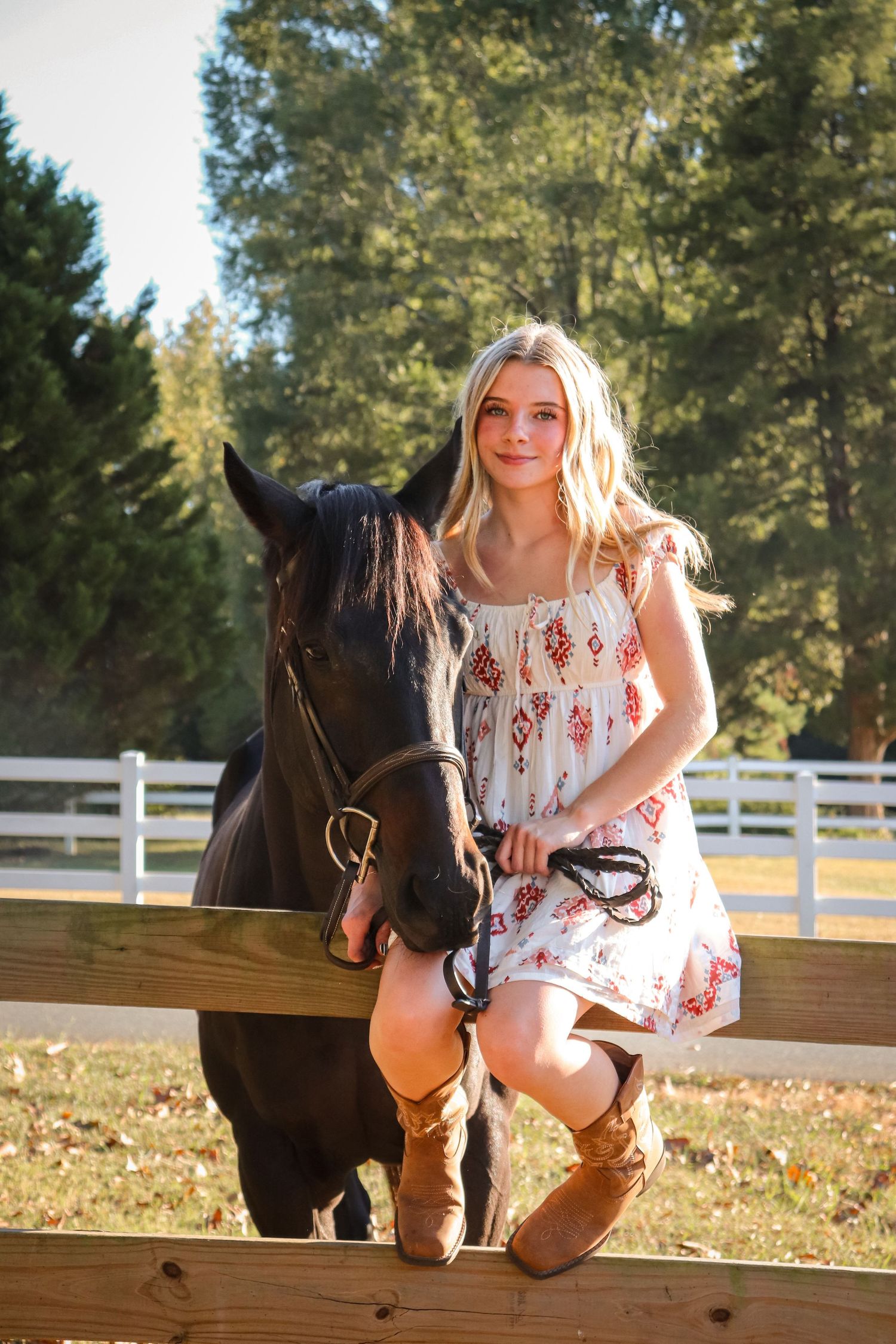 Portrait of a girl and her horse, taken outdoors in warm natural light.
