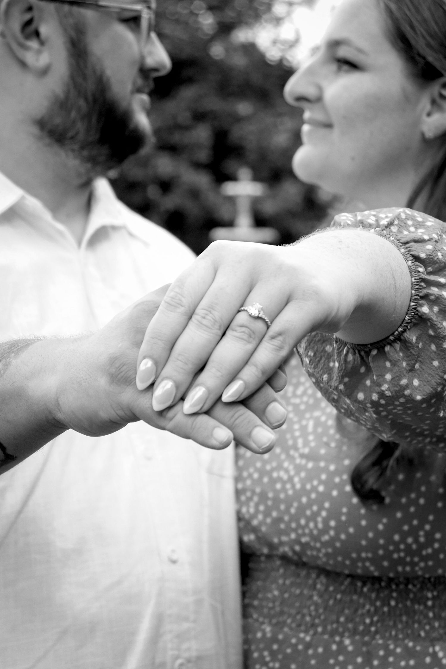 Engagement session, woman showing off engagement ring photographed in black and white.