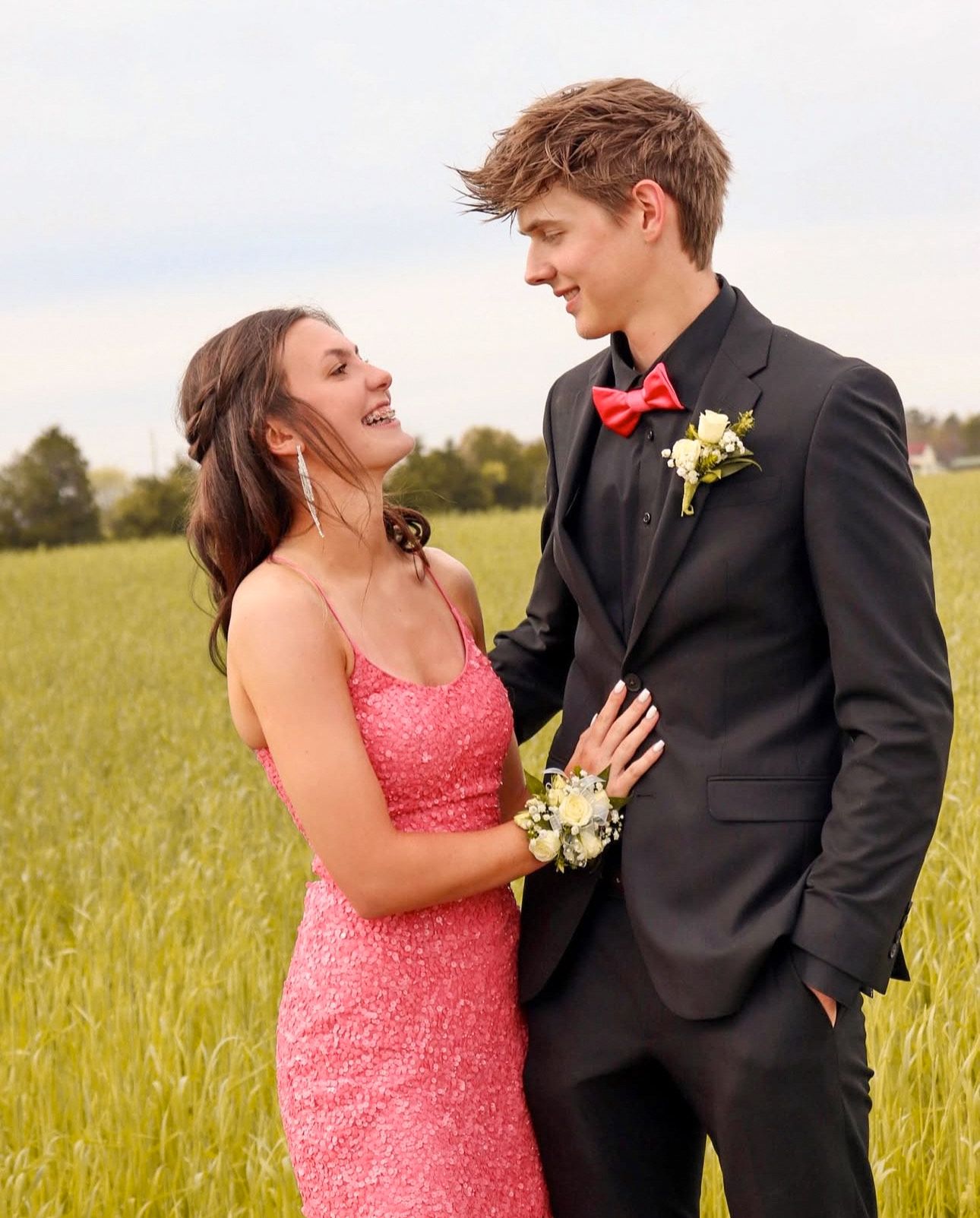 Sweet candid moment of a couple sitting together leaning in for an intimate, natural portrait.