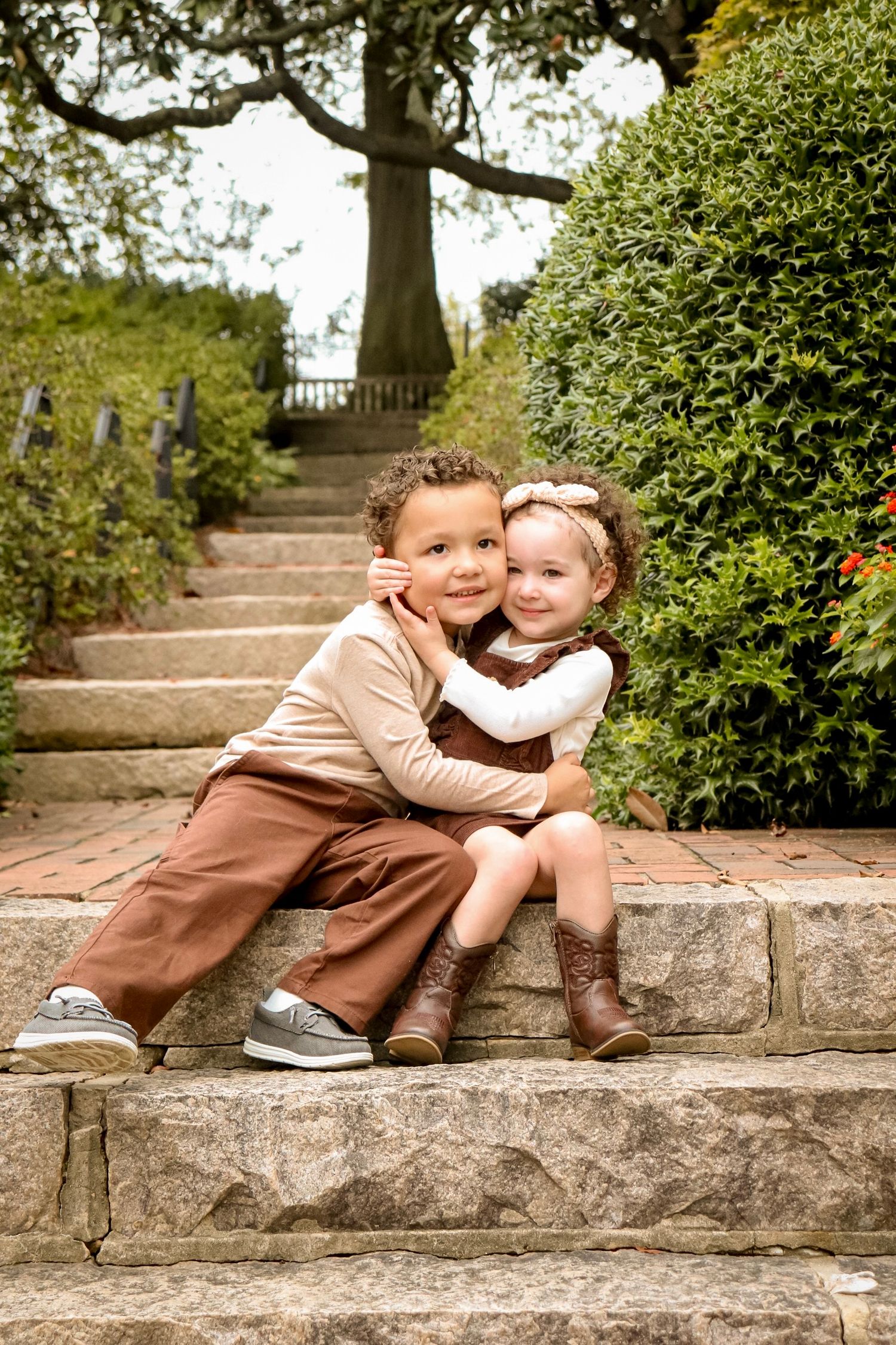 Lifestyle family session with two children taken outdoors in natural light, candid photography style.