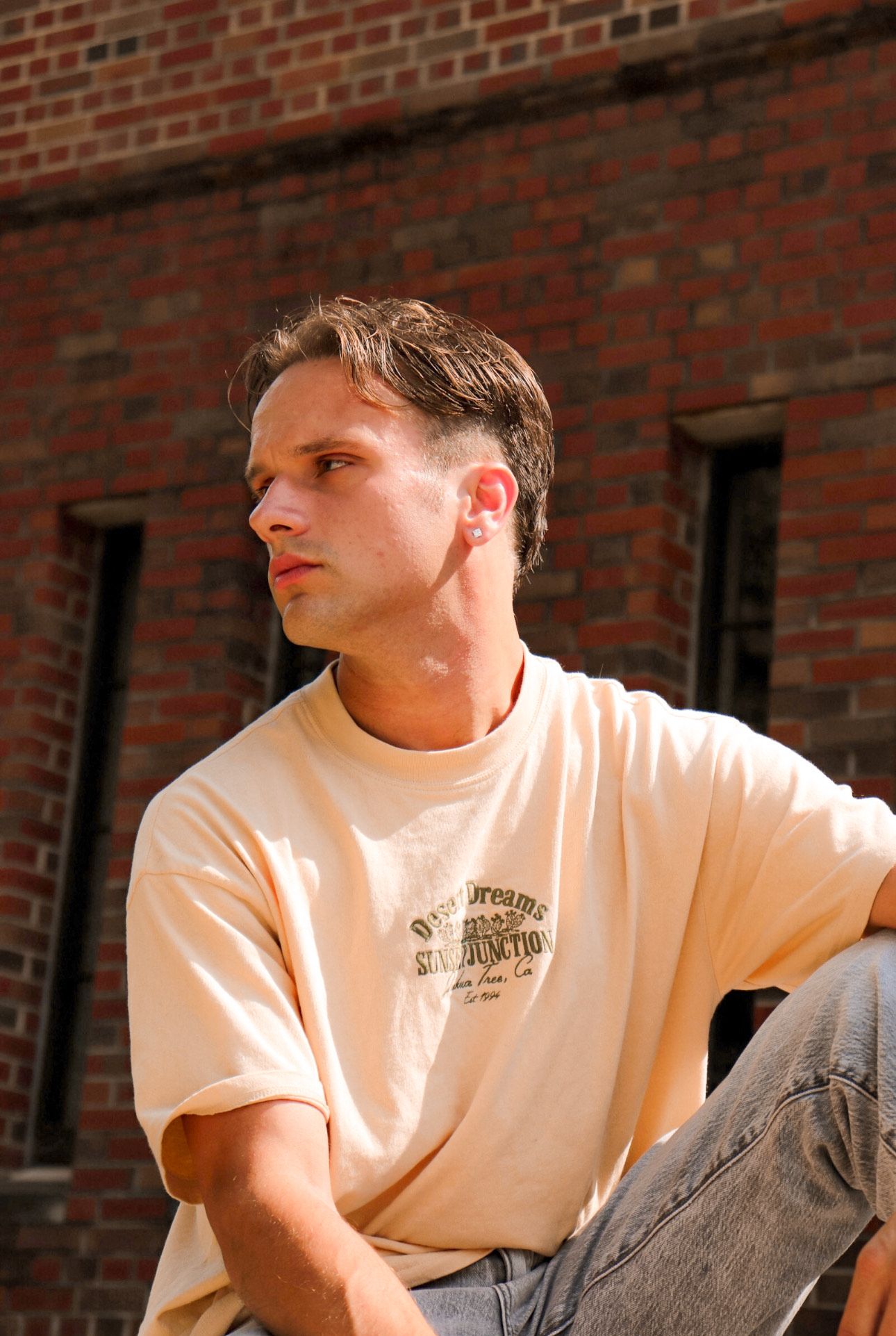 candid portrait of a man glancing to his left, taken outdoors