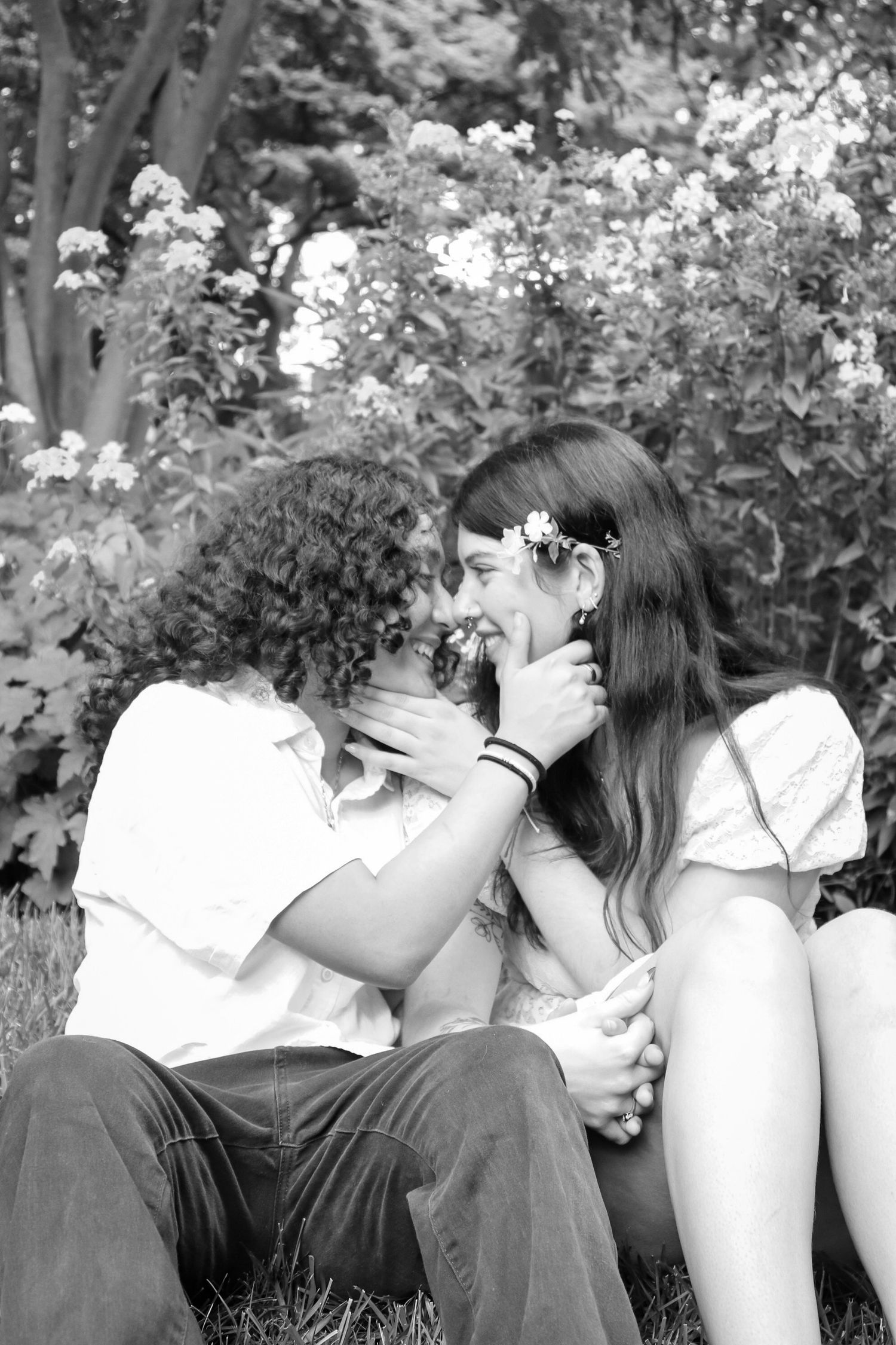 Sweet candid moment of a couple sitting together leaning in for an intimate, natural portrait.