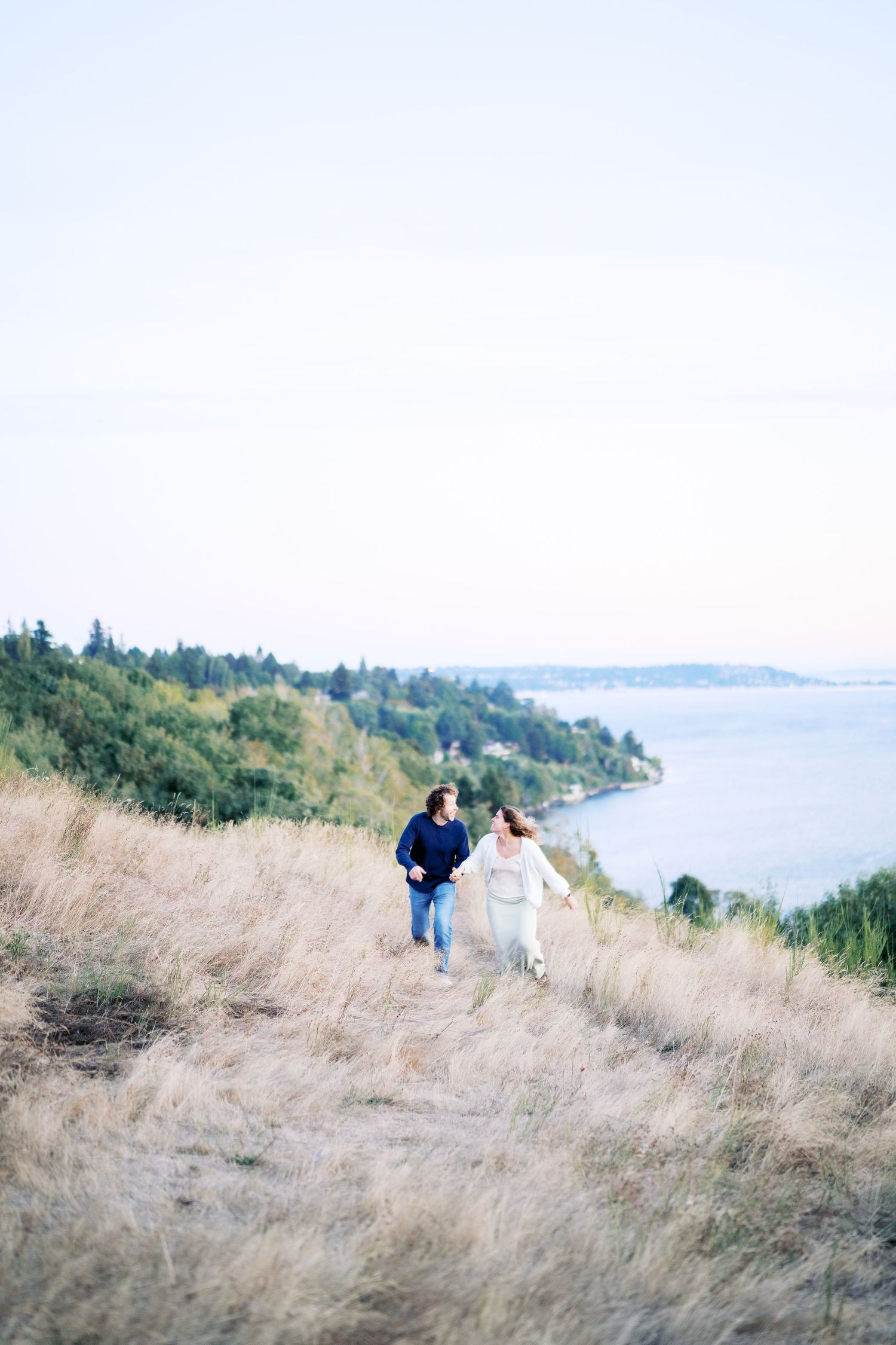 Wide view of the meadow and the water at Discovery Park, proposal photographer, Seattle