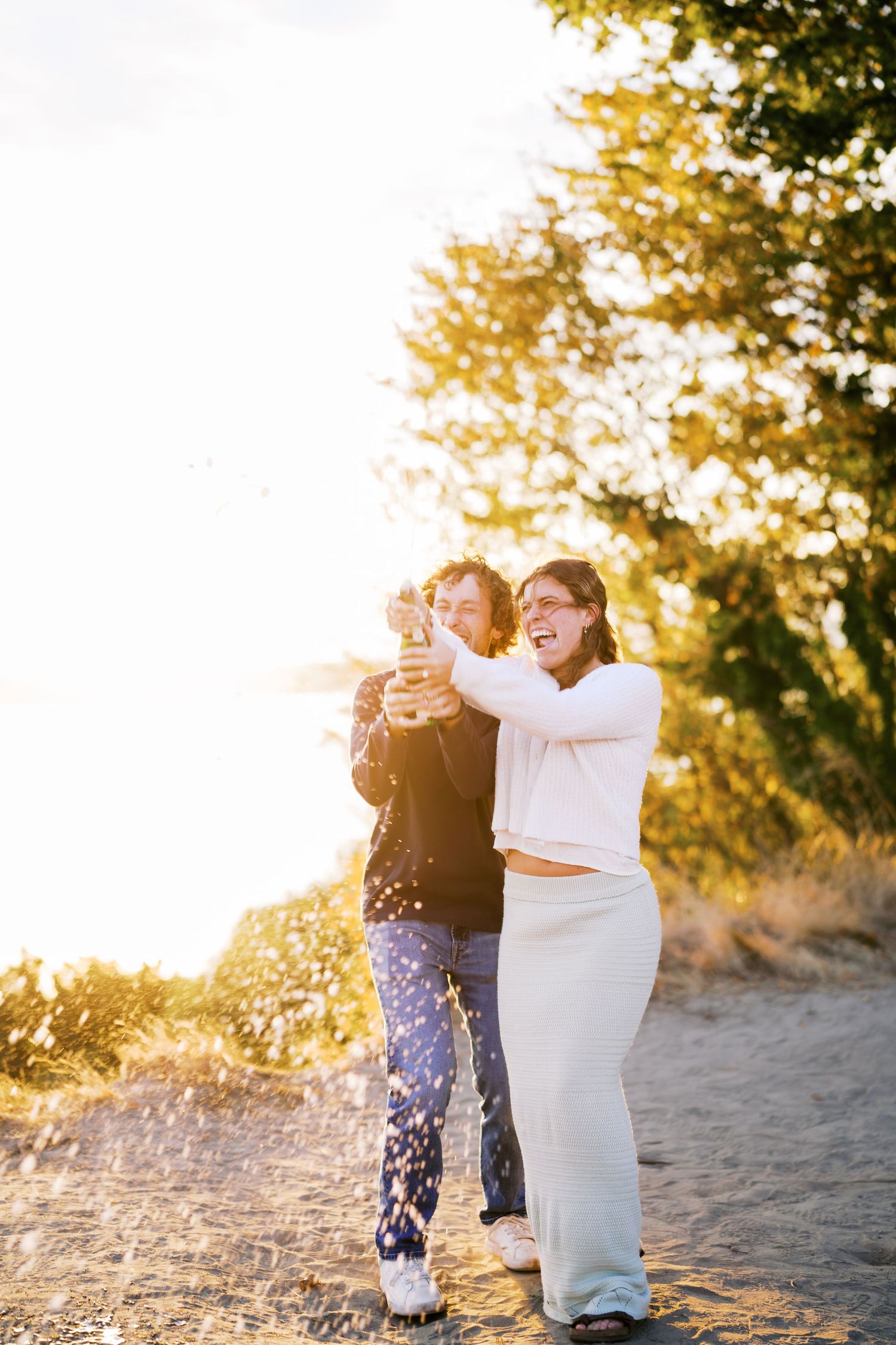 Holding each other on the path at sunset, Discovery Park proposal photographer, Seattle