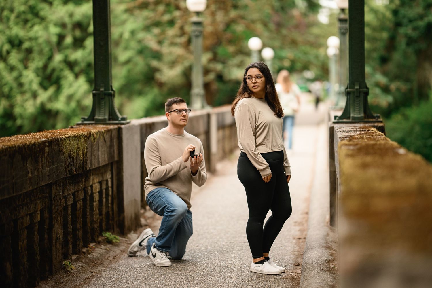 Man down on one knee with the ring box on the footbridge, Washington Park Arboretum proposal photographer, Seattle