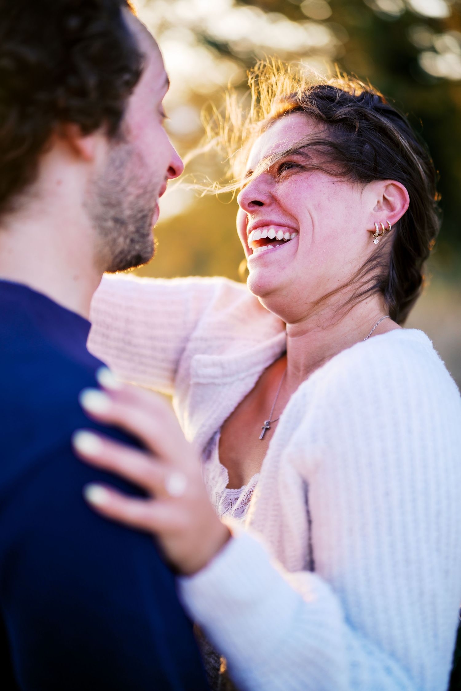 Laughing together with champagne as the light drops, Discovery Park proposal photographer, Seattle