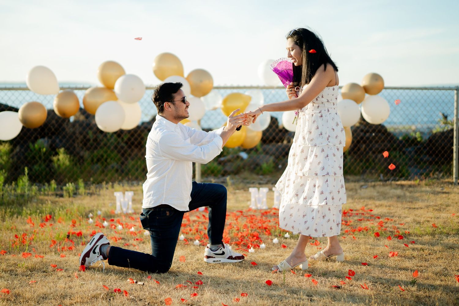 He lifts her off the ground after she says yes, West Point Lighthouse proposal photographer, Seattle