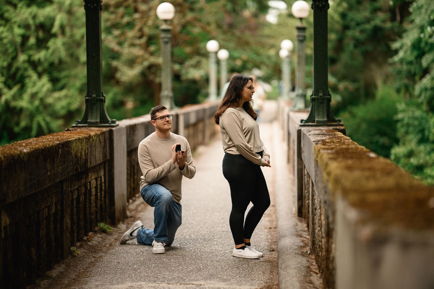 Surprise proposal on one knee between the bridge lampposts, Arboretum proposal photographer, Seattle