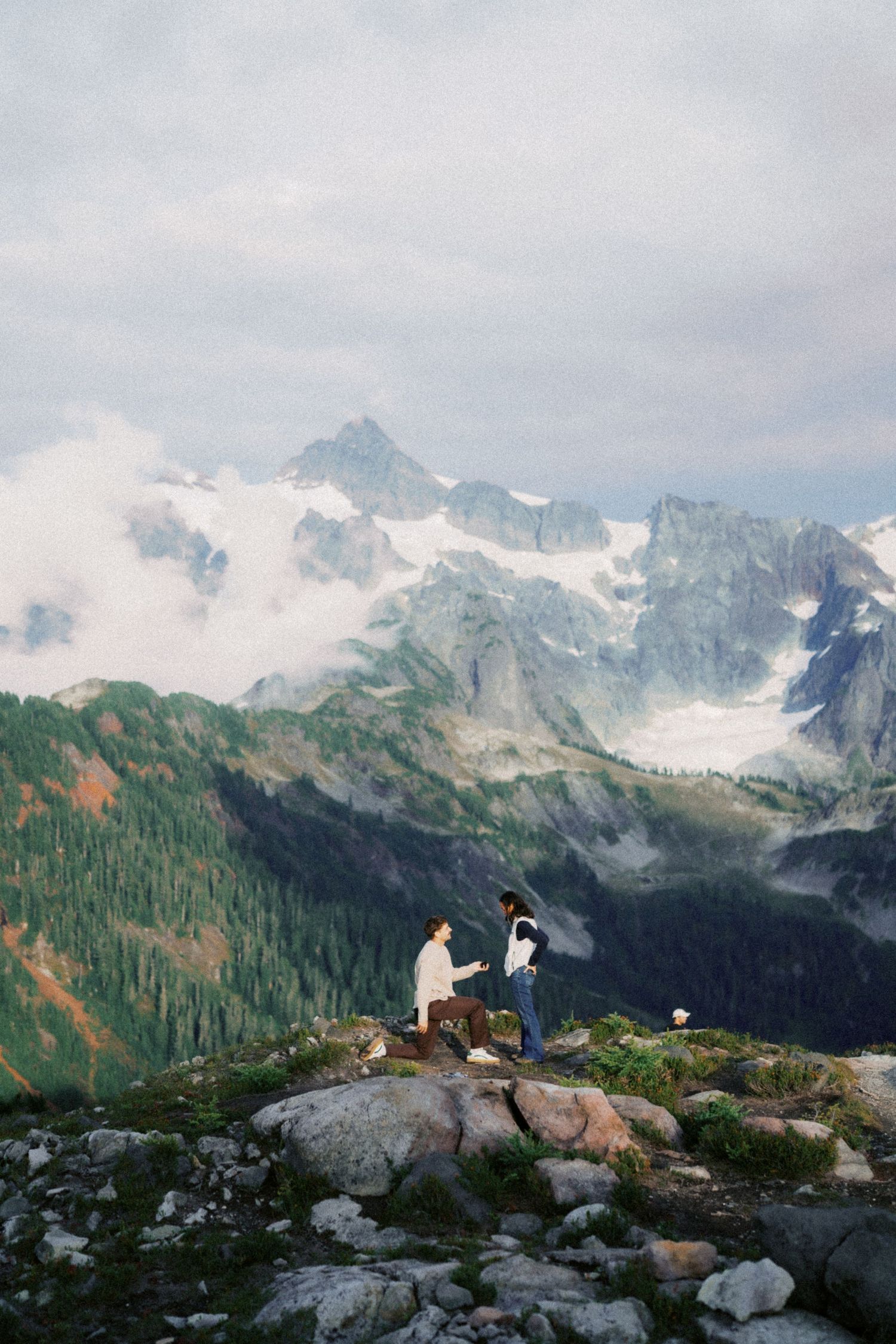 Tiny figures on the rock as he asks her, Artist Point proposal photographer, Mt Baker