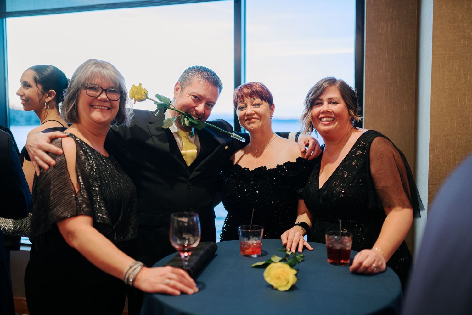 Guests with drinks at a cocktail table by the windows, corporate gala photographer in Renton