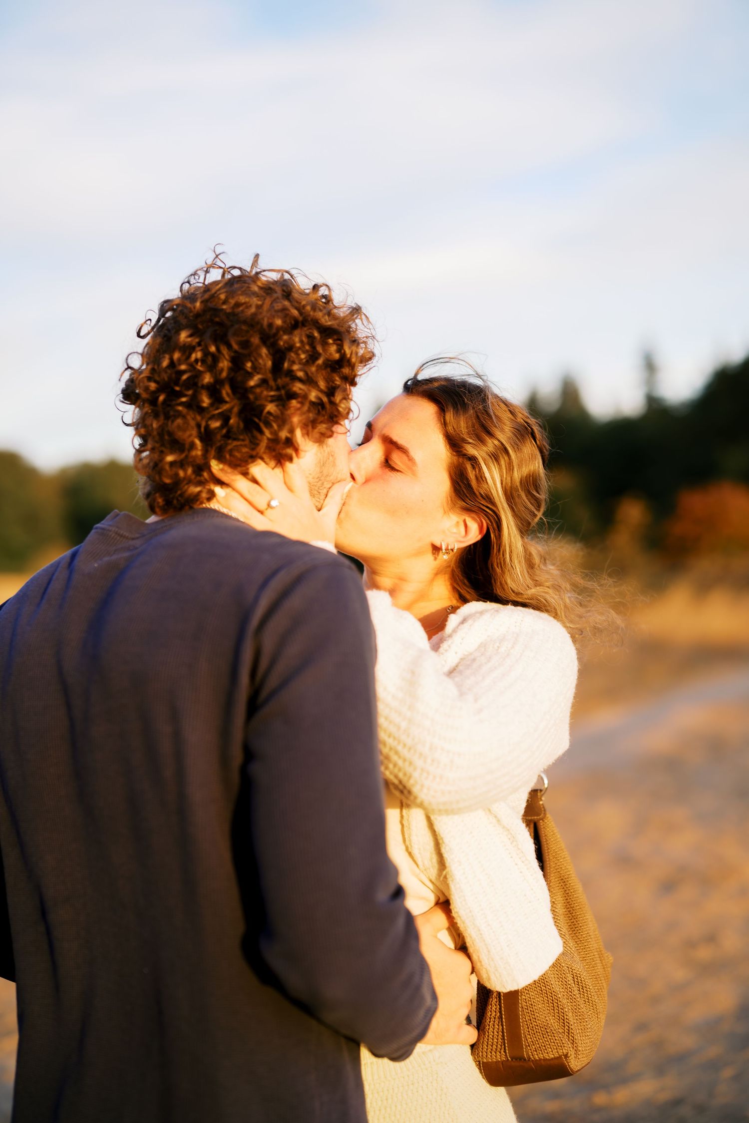 Kissing in the last of the golden light, Discovery Park proposal photographer, Seattle