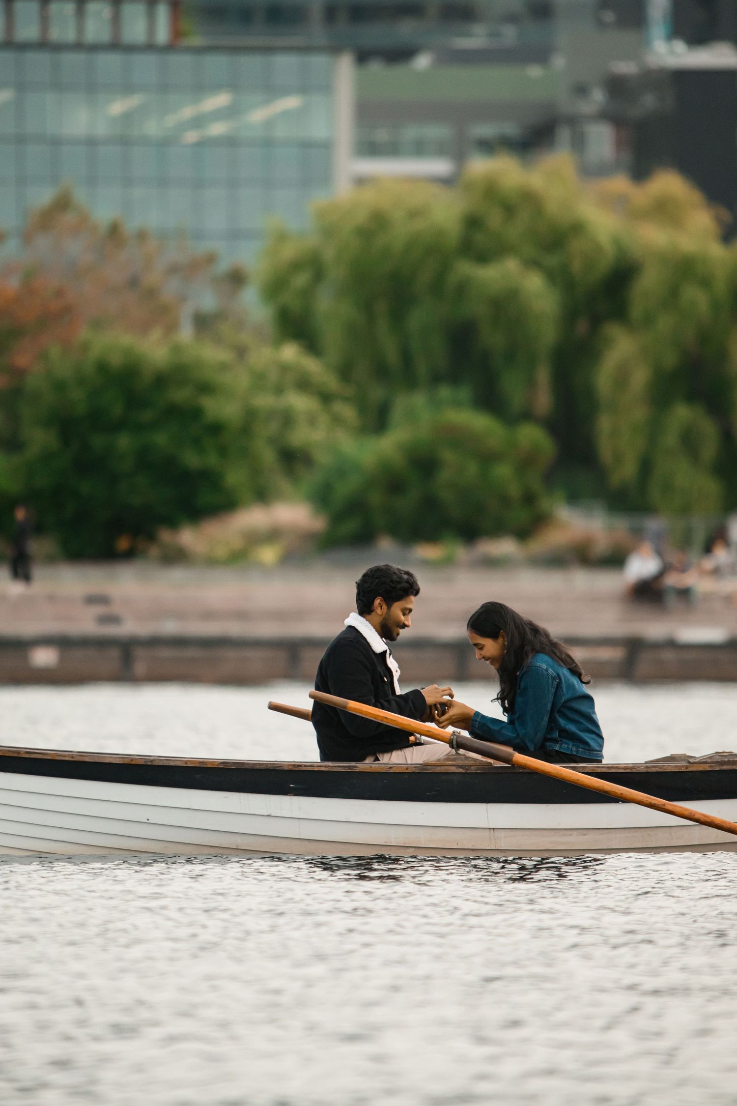 Wooden row boat on the water with the willows on the shoreline behind, Lake Union proposal photographer, Seattle