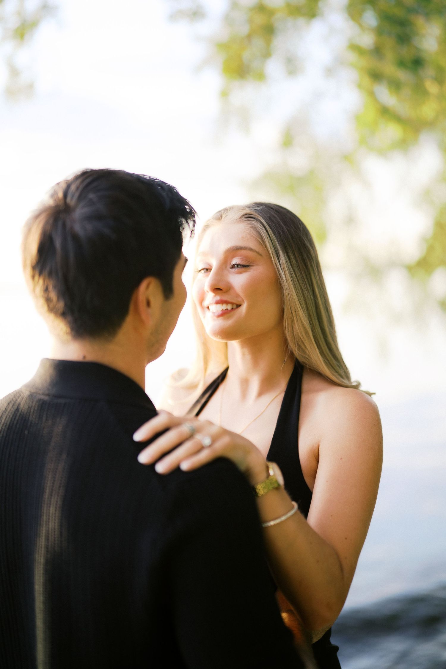 Newly engaged couple laughing together, Carillon Point proposal photographer, Kirkland