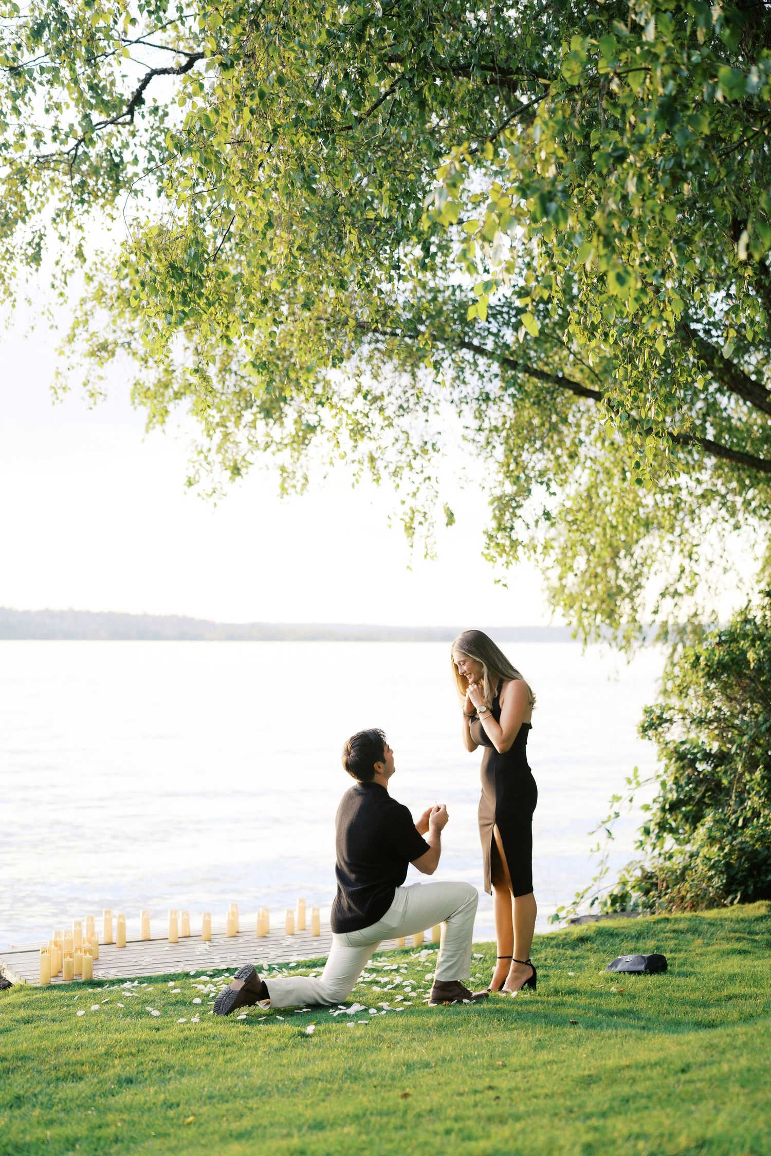 Her hands go to her face as he proposes at Carillon Point, Kirkland proposal photographer