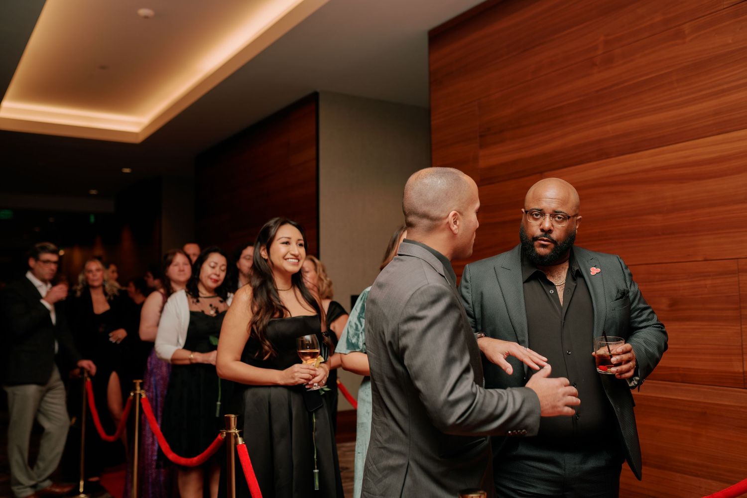 Guests greeting each other as they arrive, candid event photography at the Hyatt Regency Lake Washington, Renton