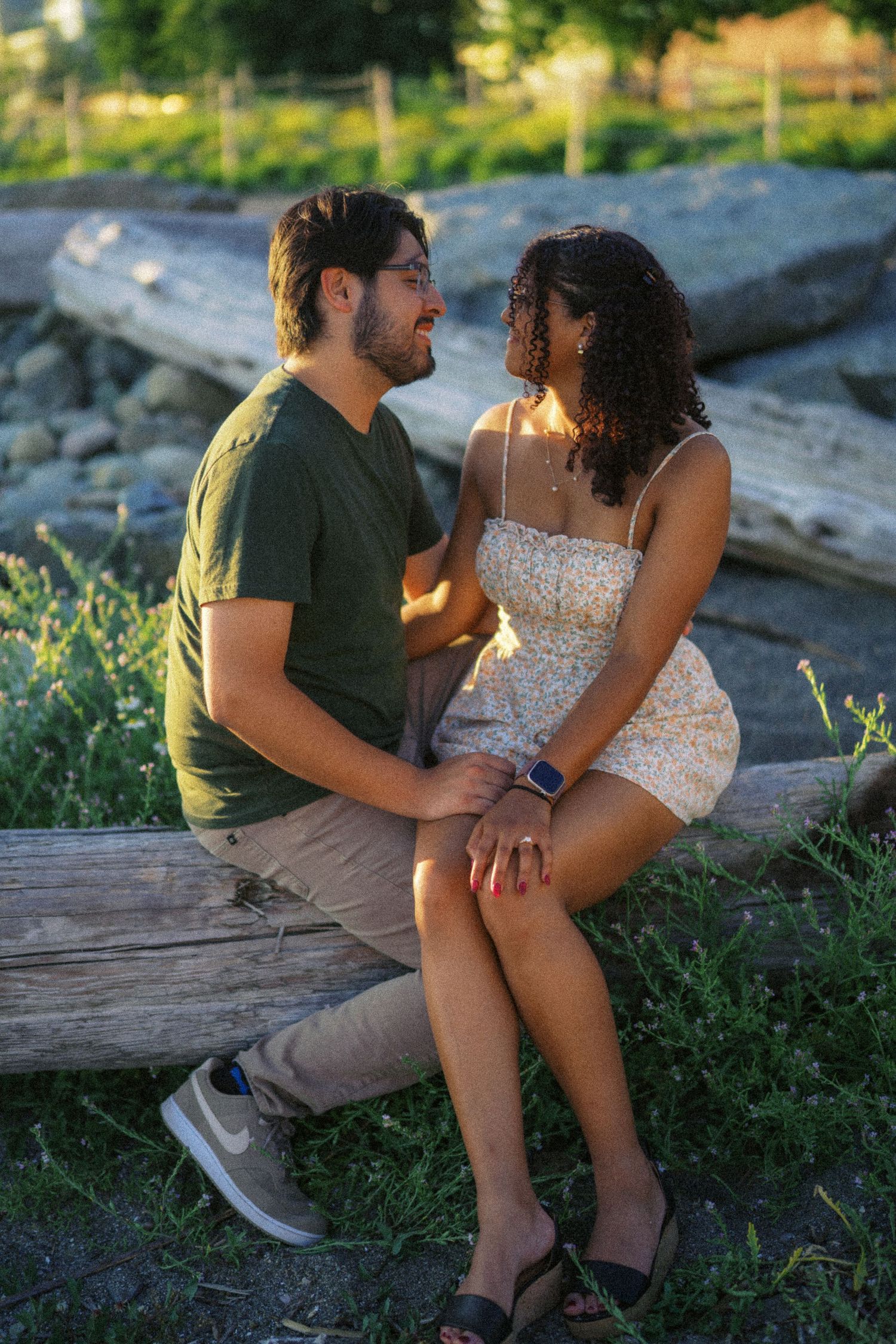 Sitting together on the rocks at sunset, Seattle proposal photography