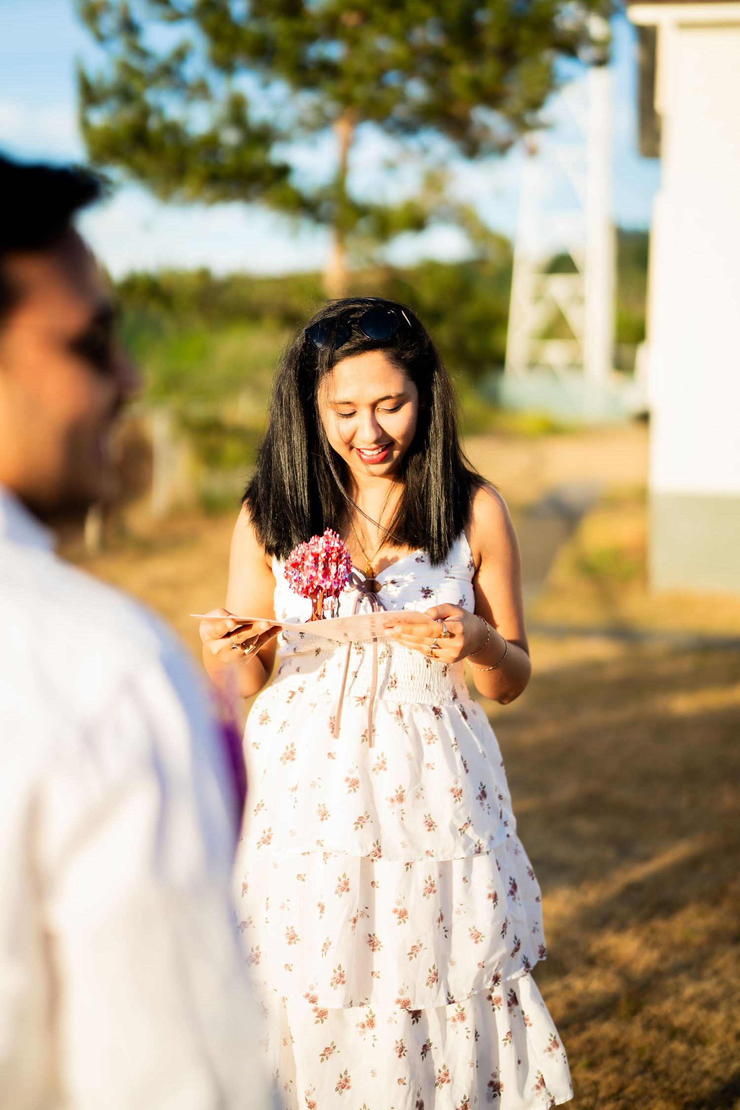 She holds the bouquet in the evening light, West Point Lighthouse proposal photographer, Seattle