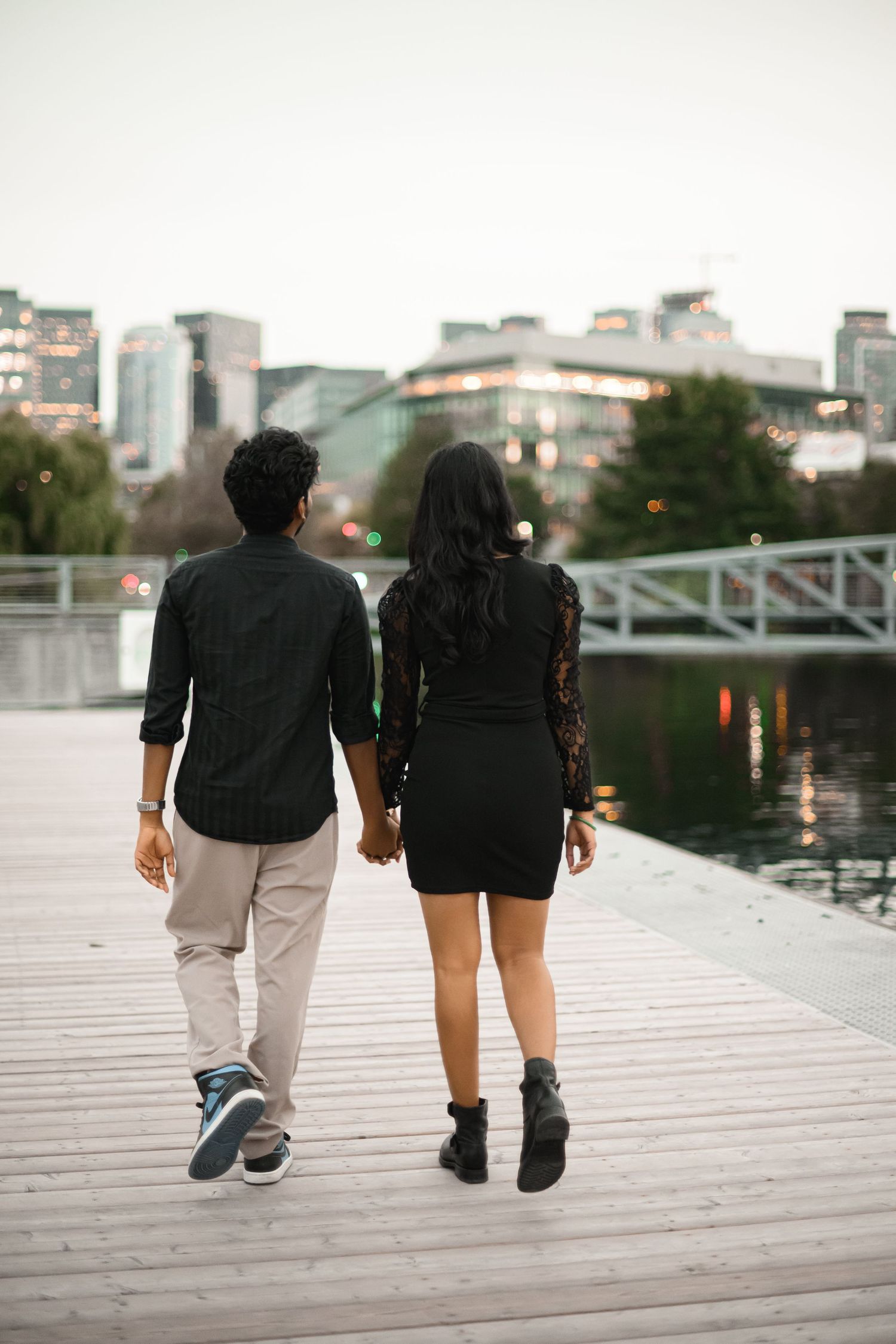 Walking away hand in hand along the dock at dusk, Lake Union proposal photographer, Seattle