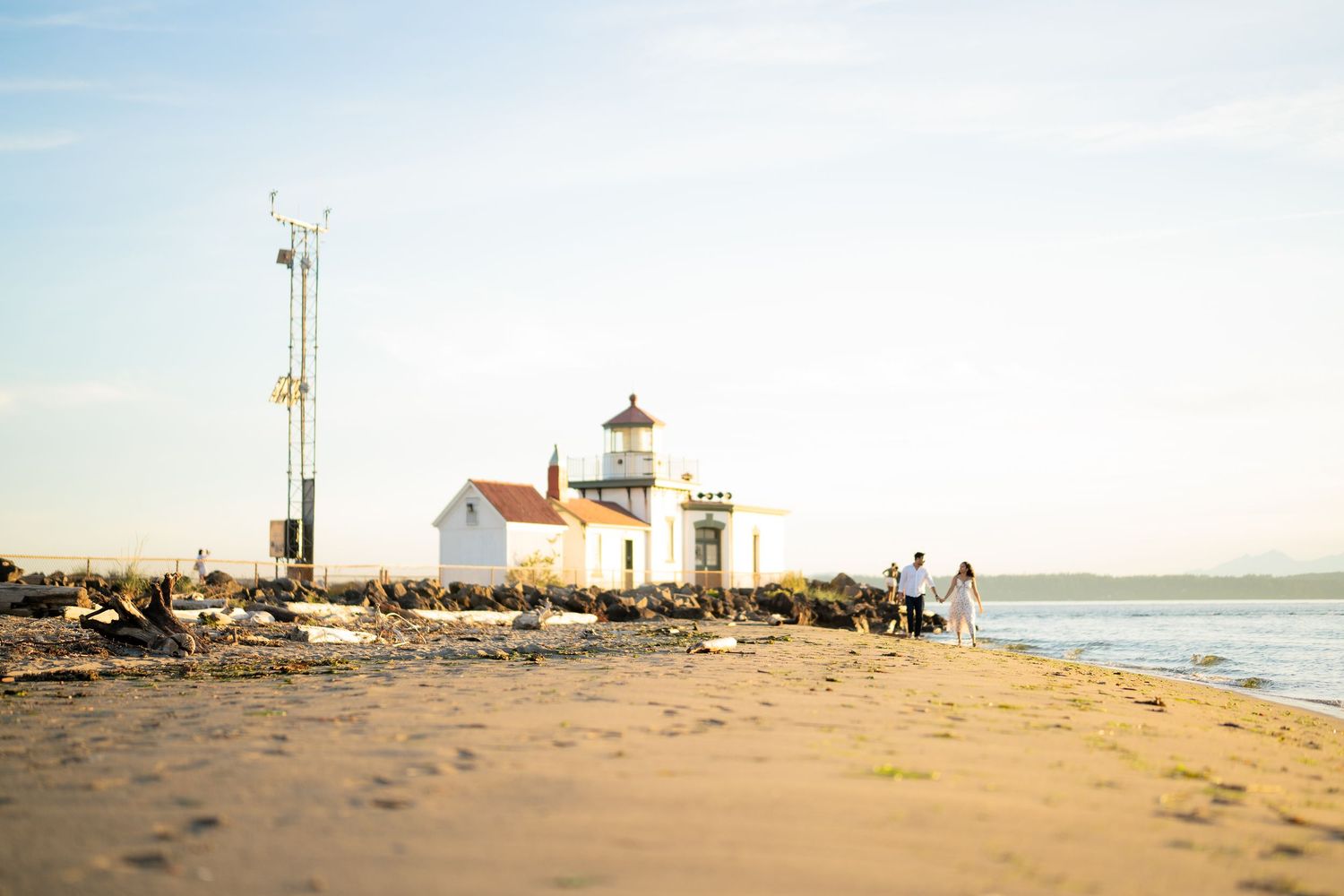 Wide view of the beach and the point at golden hour, West Point Lighthouse proposal photographer, Discovery Park