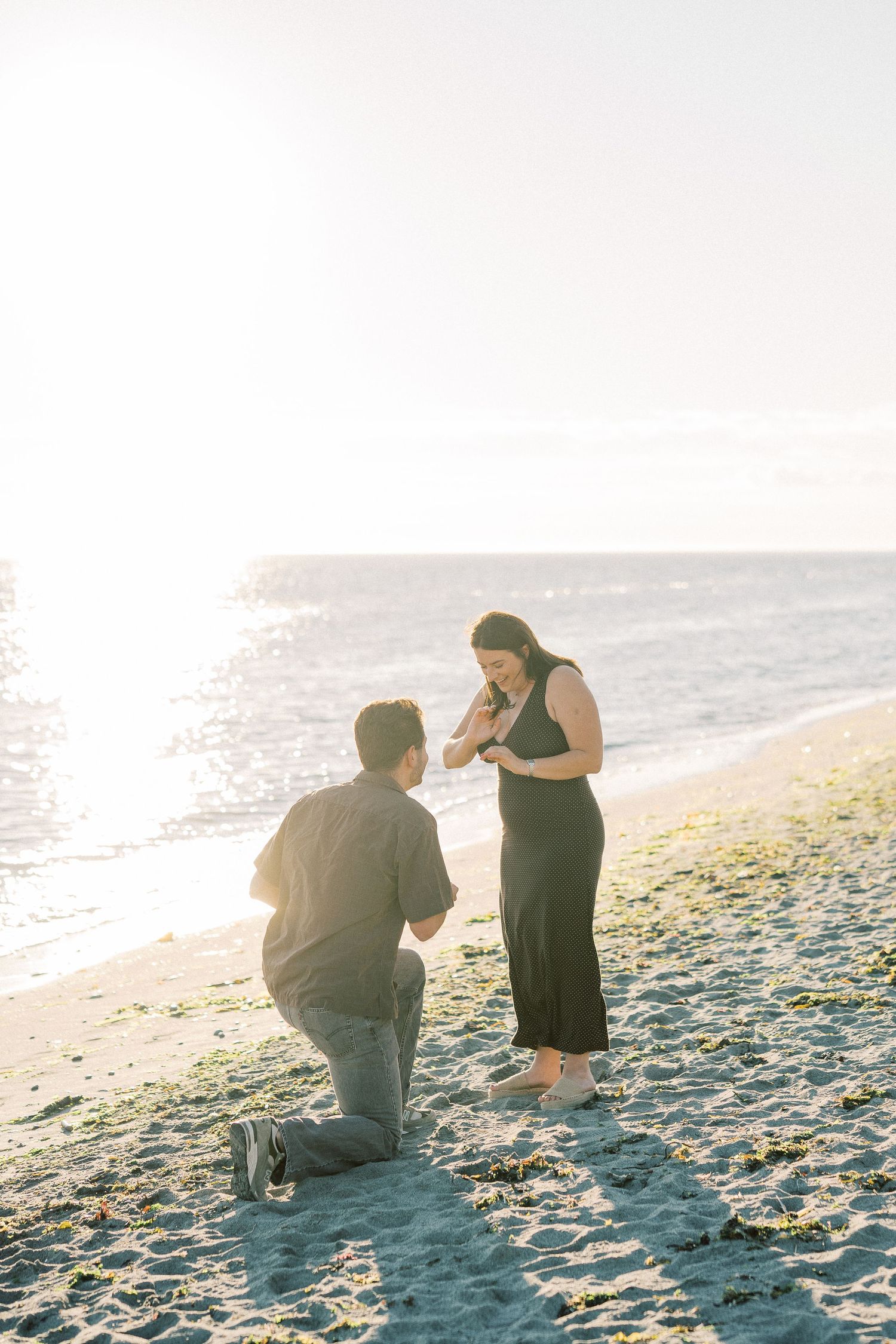 Man on one knee proposing on the sand, Whidbey Island proposal photographer, Freeland