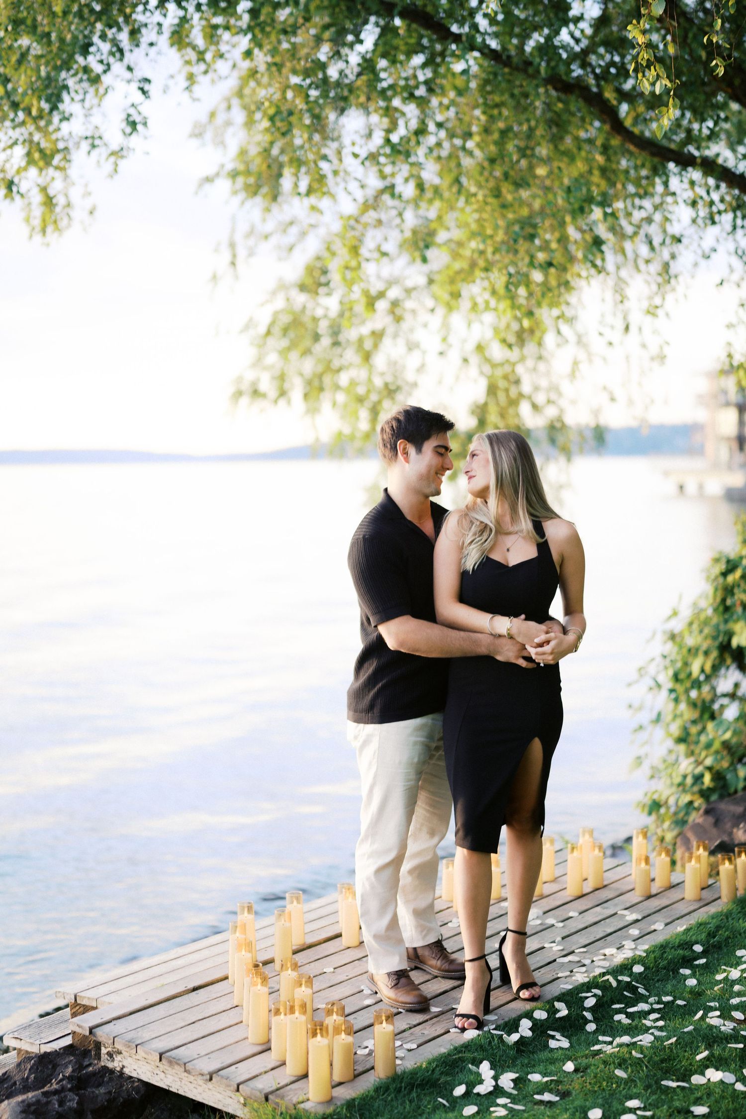 Backlit portrait of the newly engaged couple by Lake Washington, Carillon Point, Kirkland