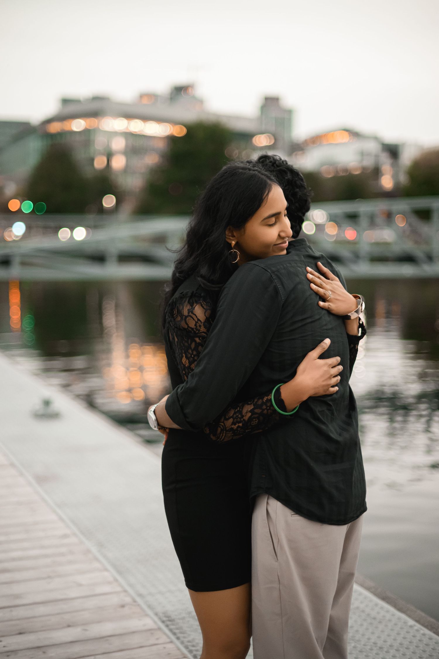 Holding on to each other as the city lights come on, Lake Union proposal photographer, Seattle