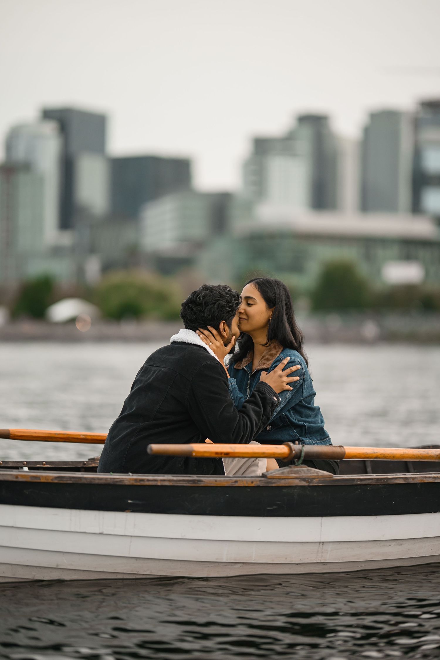 Kissing in the wooden boat right after she said yes, Lake Union proposal photographer, Seattle
