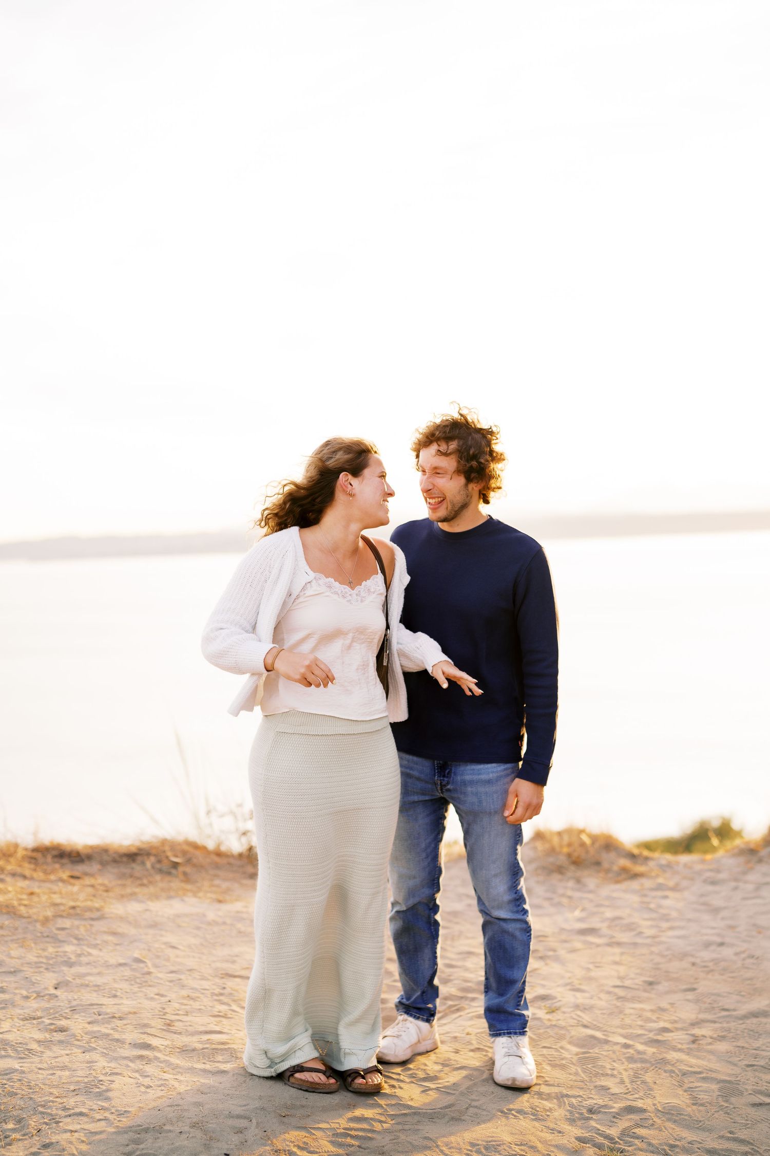 First embrace as an engaged couple, Discovery Park proposal photographer, Seattle