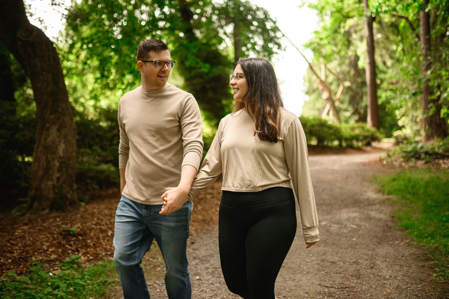 Couple laughing as they walk an Arboretum path in July, Arboretum proposal photographer, Seattle