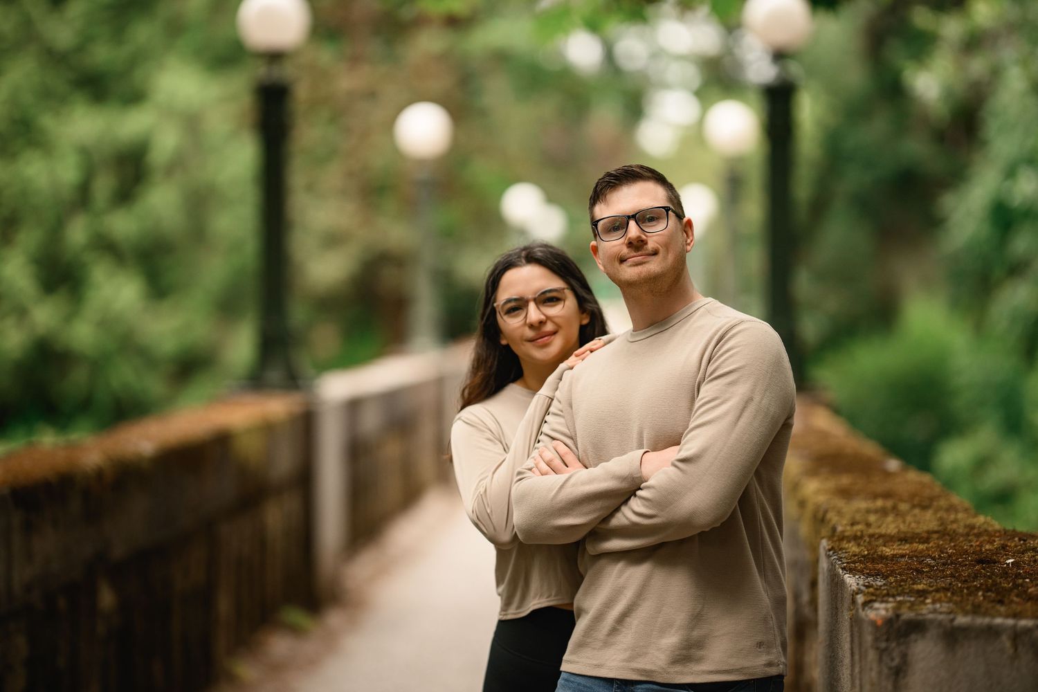 Newly engaged couple on the footbridge looking at the camera, Washington Park Arboretum proposal photographer, Seattle